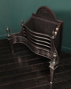 A Georgian Revival Polished Steel Fire Grate