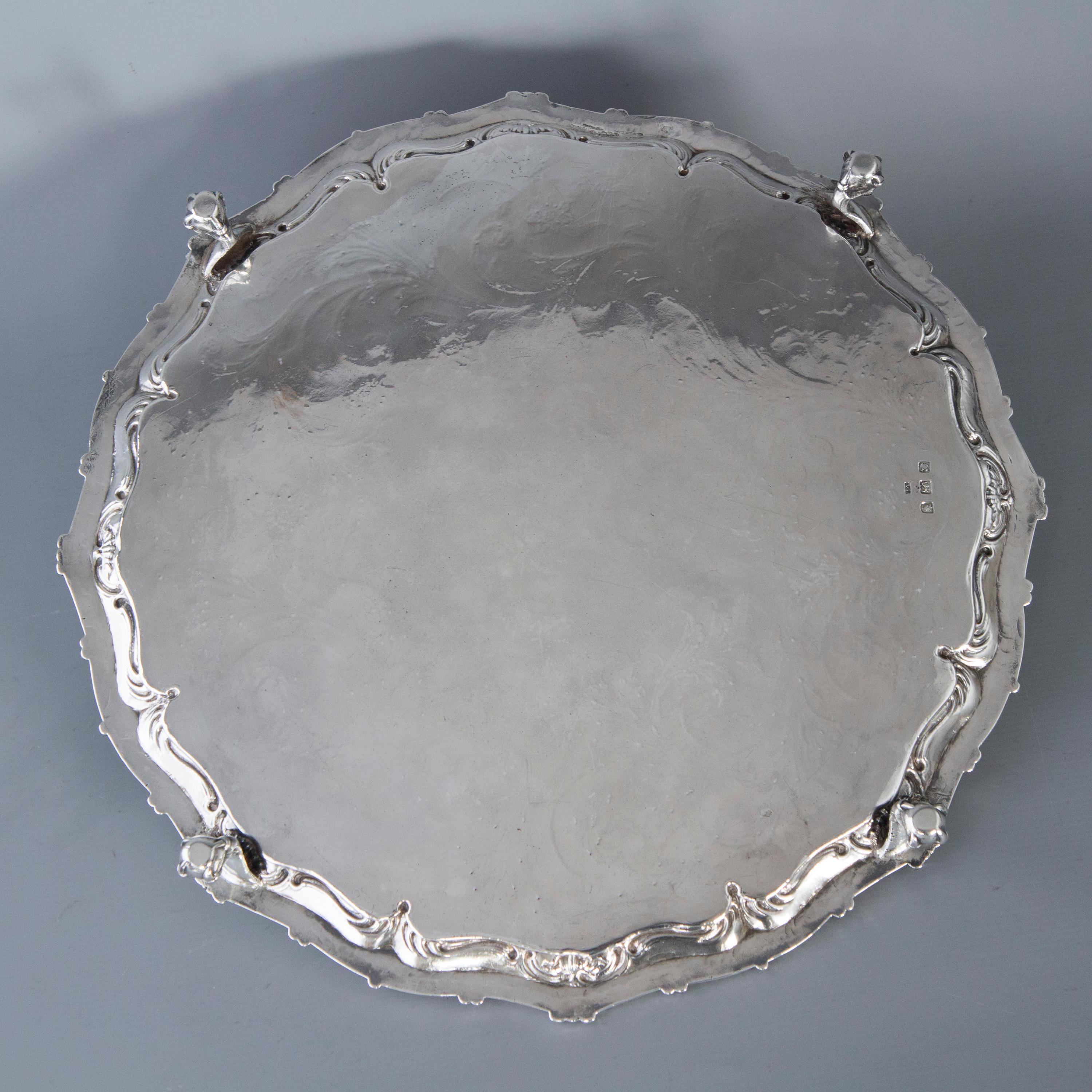 A very good large George III silver salver of circular form. The cast border of shell and scrolling beaded decoration. The central plate bright cut engraved with flowers and foliage. The centre with an armorial crest within a shaped cartouche. The