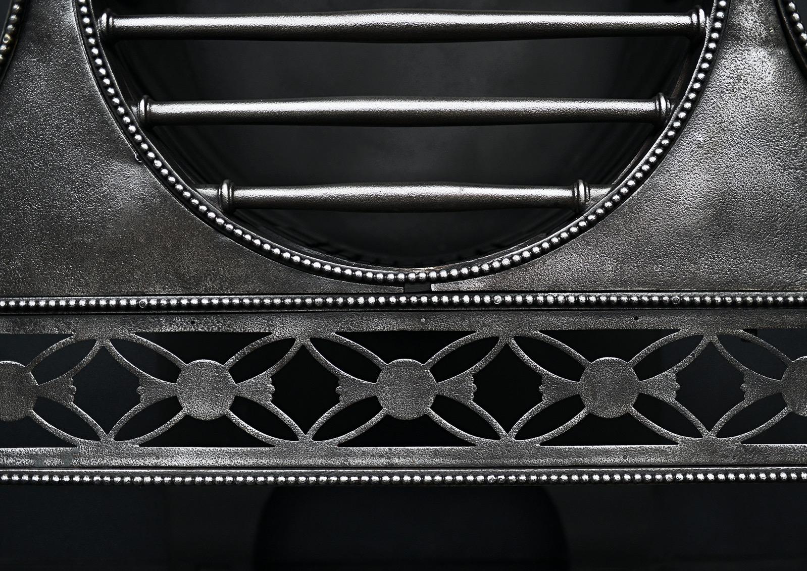A polished cast iron fire grate in the Georgian style. The tapering legs with paterae, the beaded, pierced fret surmounted by bowel shaped burning area. Good quality patina to iron. English, 19th century. 

Sizes:
Width At Front:	905 mm      	35 5/8