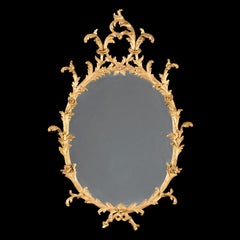A Georgian Style Oval Rococo Giltwood Mirror