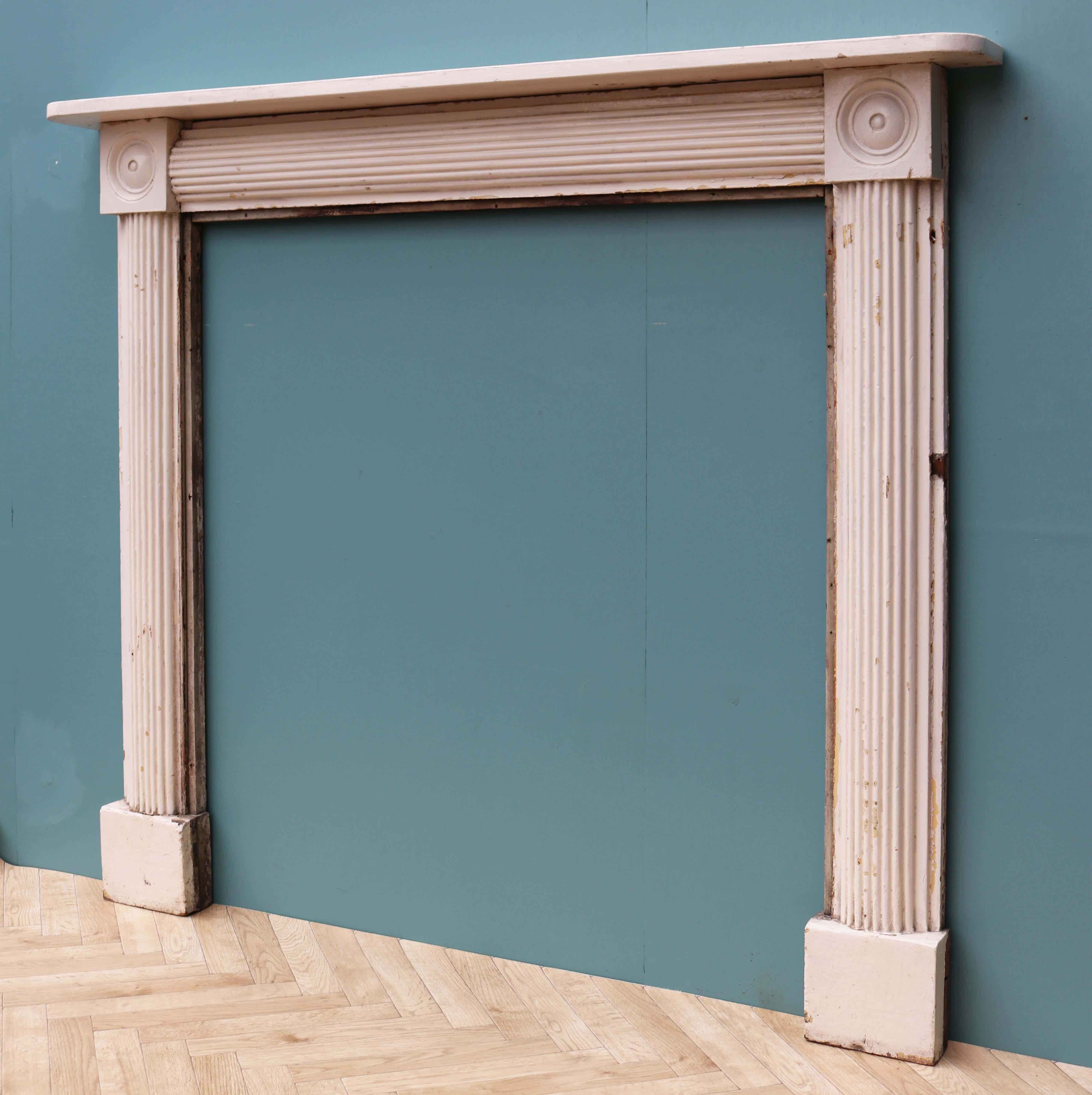 A painted Georgian period bullseye fire surround with fluted frieze and jambs. This fireplace was salvaged from a house in Maidstone, Kent.

Additional dimensions:

Opening height 112.5 cm

Opening width 106 cm

Width between outside of foot
