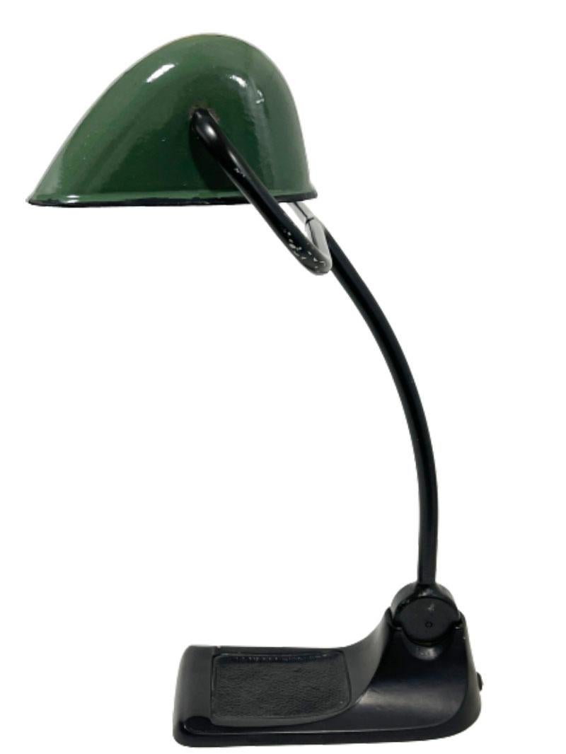 A German Bur Bauhaus desk lamp

In the Bauhaus style ca. 1920 a German BuR desk lamp with an enameled lampshade in the color dark green on a black cast iron base.
The arm and the shade are movable

The measurements are: 
42 cm (16.5 Inch)