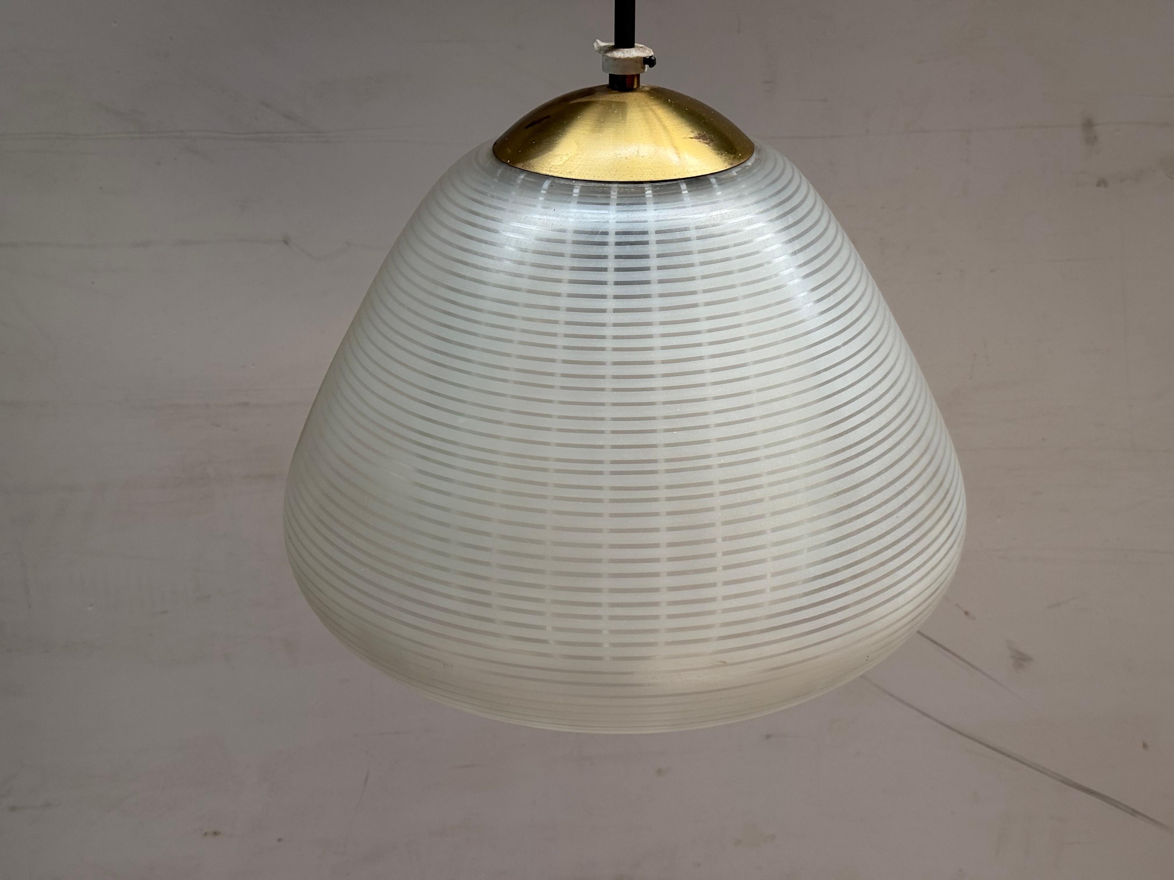 Striking midcentury modern pendant light by Wilhelm Wagenfeld, featuring a sculptural etched outer shade and a soft, opaline glass inner diffuser for a warm, ambient glow.