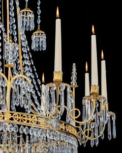 A German Neoclassical Silver And Gilt Bronze Twelve Light Crystal Chandelier