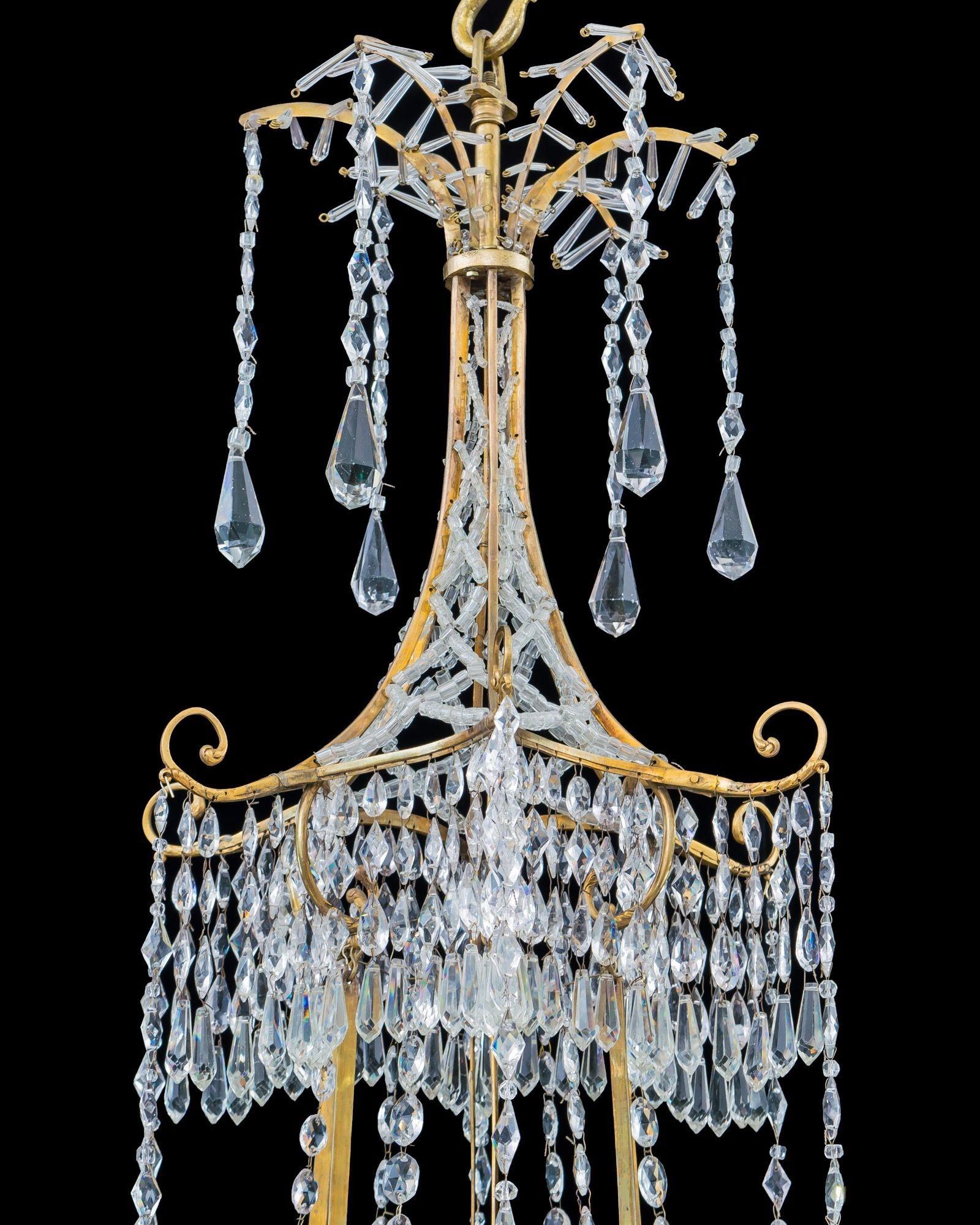 Glass A German Neoclassical Silver And Gilt Bronze Twelve Light Crystal Chandelier  For Sale