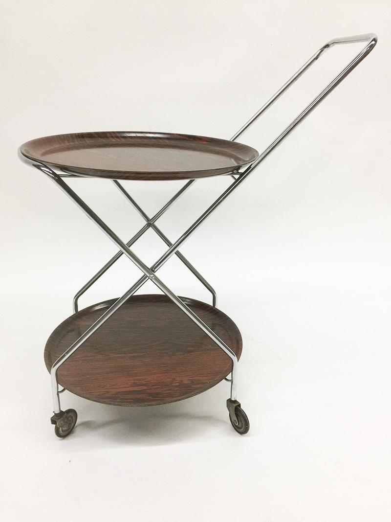 A German folding serving trolley, 1970s

A serving trolly with 2 removable trays and marked on the bottom with label
Made in Western Germany an original PK, with melanin resin on both sides
Numbered with 5590/6
When you remove the 2 trays, a bracket