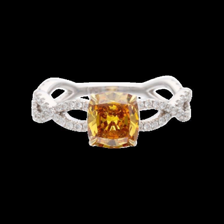 Centering an orange diamond, accented by round brilliant cut diamonds.
 - Orange diamond weighs 1.16 carats 
- Round brilliant cut diamonds weighing a total of approximately 0.80 carat 
- Size 6 3/4
 - Total weight 2.77 grams 
- 18 karat white and