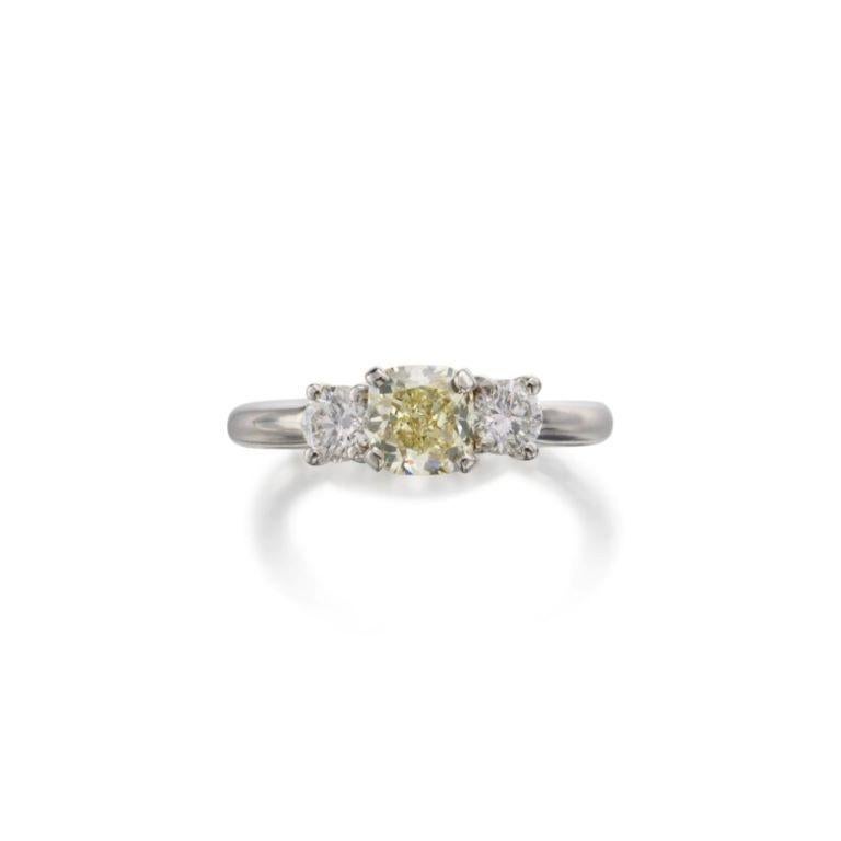 Centering a Fancy Yellow diamond, flanked by 2 round brilliant diamonds.
 - Fancy yellow diamond weighs a total of 1.00 carats
 - Round brilliant diamonds weighing a total of approximately 0.50 carat
 - 18 karat yellow gold and platinum
 - Size 6½