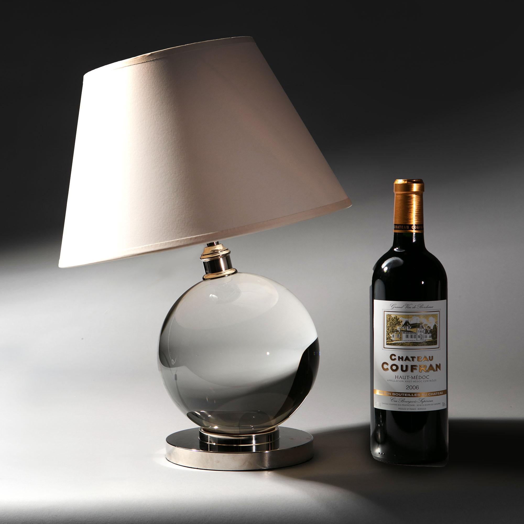 A giant crystal ball lamp resting on a circular silver base, after a design by Jacques Adnet.

Please note: lampshade not included. Wine bottle for scale.

Currently wired for the UK.