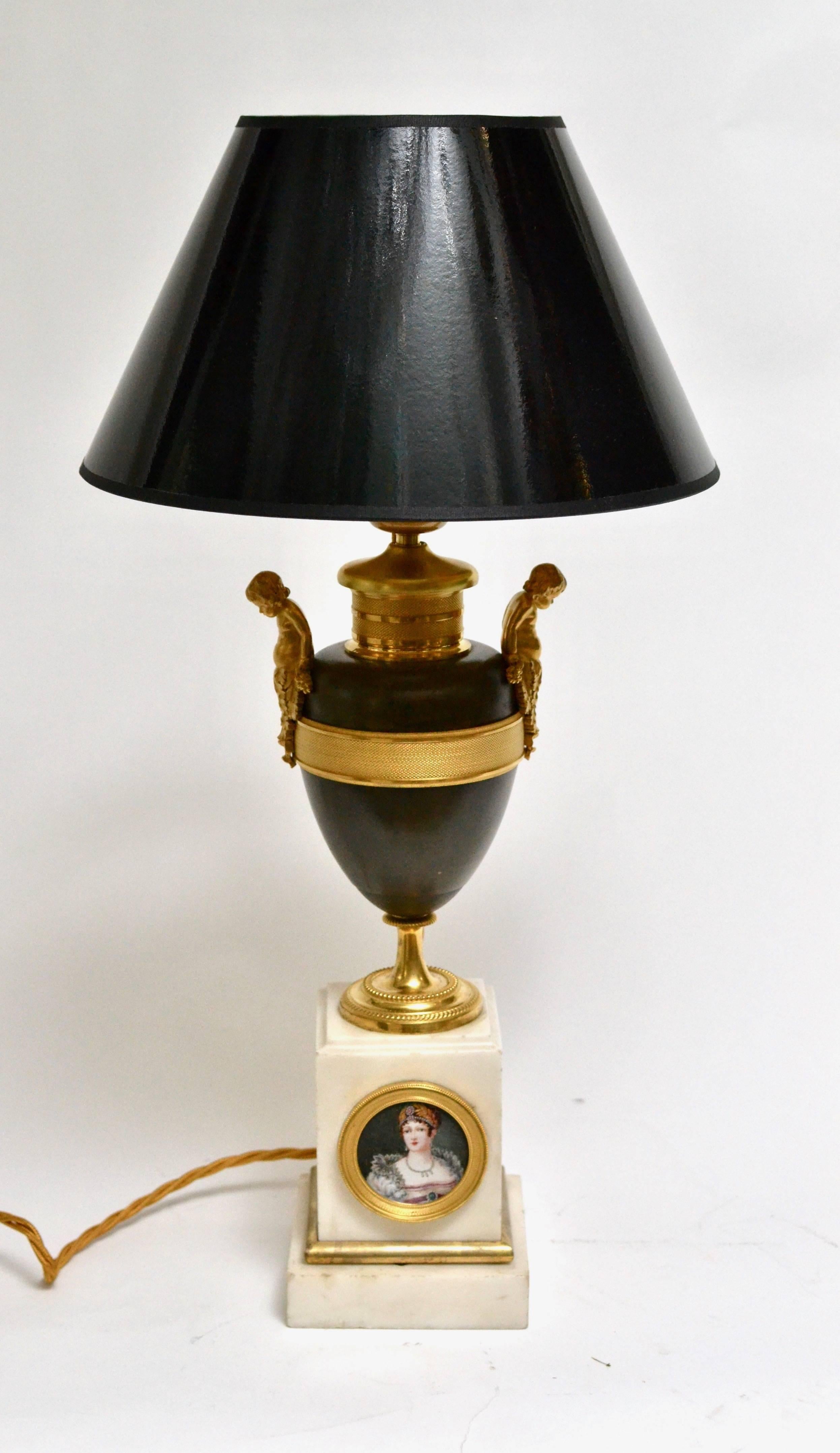A gilt and patinated Empire bronze urn a white marble base with a painted miniature of empress Josephine (1763-1814), Napoleons first wife. Now mounted as a lamp.