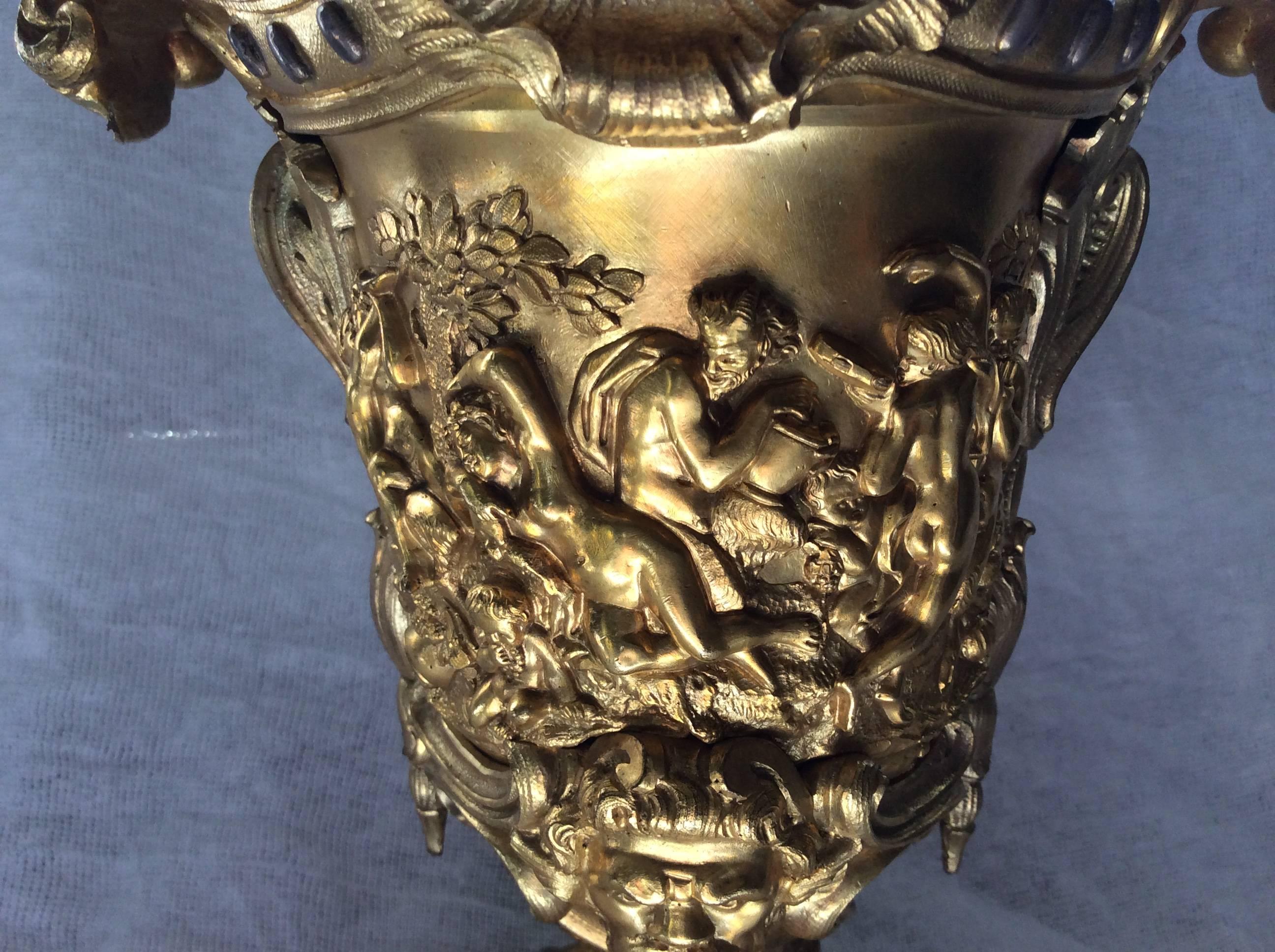 A gilt bronze table lamp, cast with bacchanale, mask and flowers
H. excluding mounting 29cm
