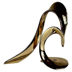 A gilt bronze abstract sculpture by Bill Keating "Surf Rider" on Lucite base