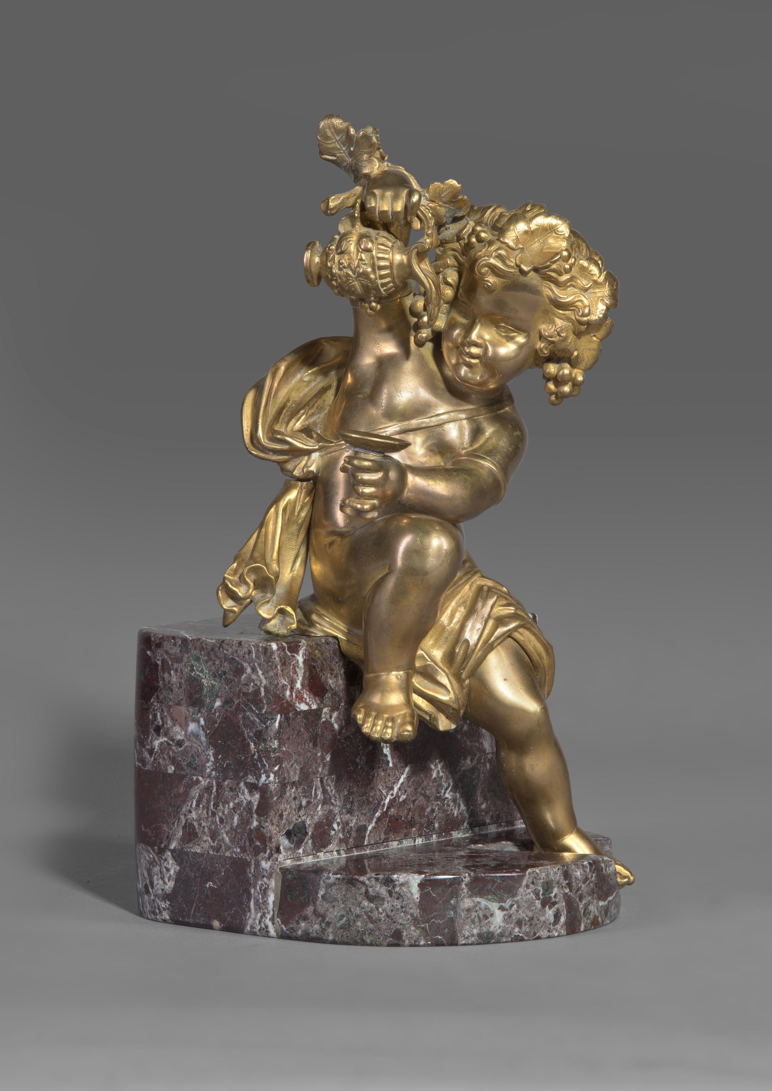 A gilt bronze bacchanalian putto figure, seated on a rouge marble plinth.

French, circa 1870. 

The figure possibly originally mounted on a piece of furniture or forming part of a larger group.
  