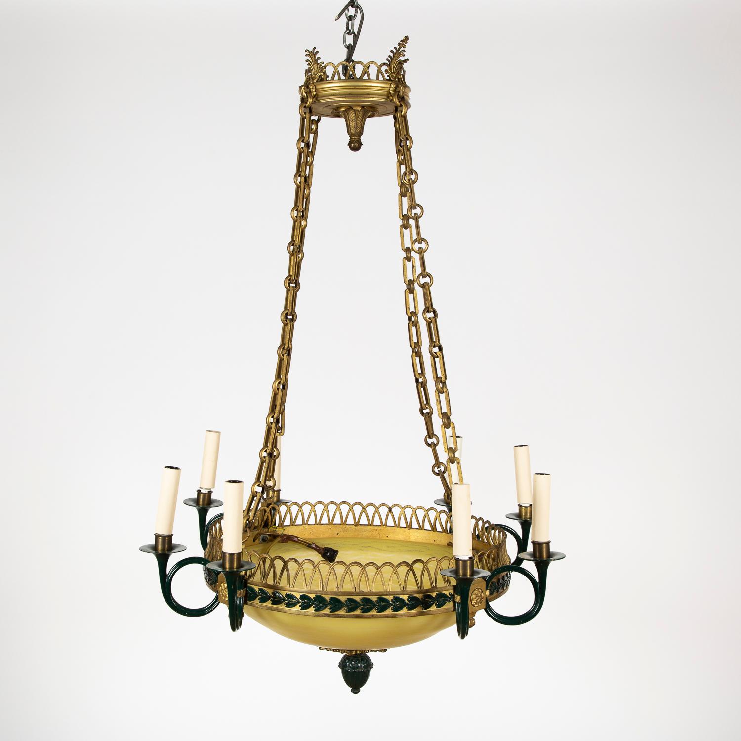A French eight light gilt bronze and colored glass chandelier in the Empire style.

 