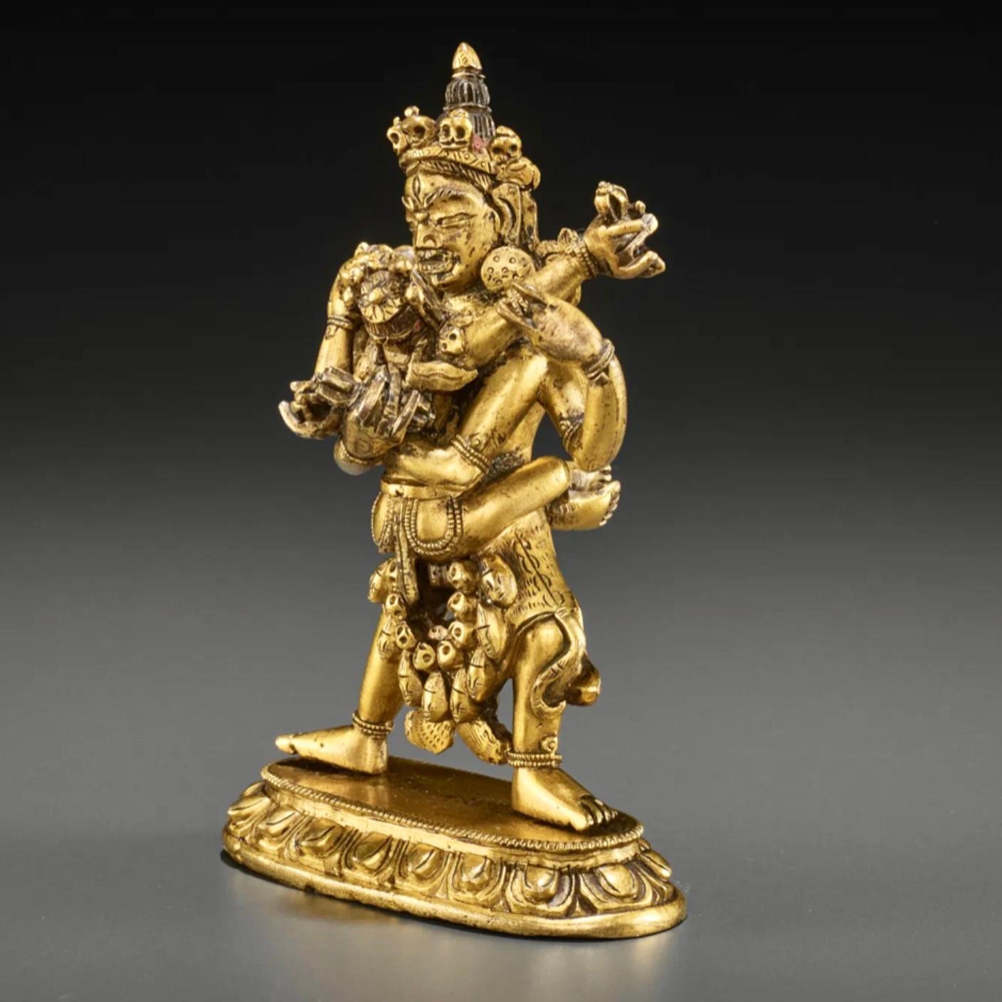 A gilt bronze figure of Chakrasamvara and Vajravahari, 17th-18th century

Tibet, 18th century. The two in embrace striding in alidhasana atop a lotus base with a beaded edge. He is holding vajra and ghanta and is adorned with a long garland of