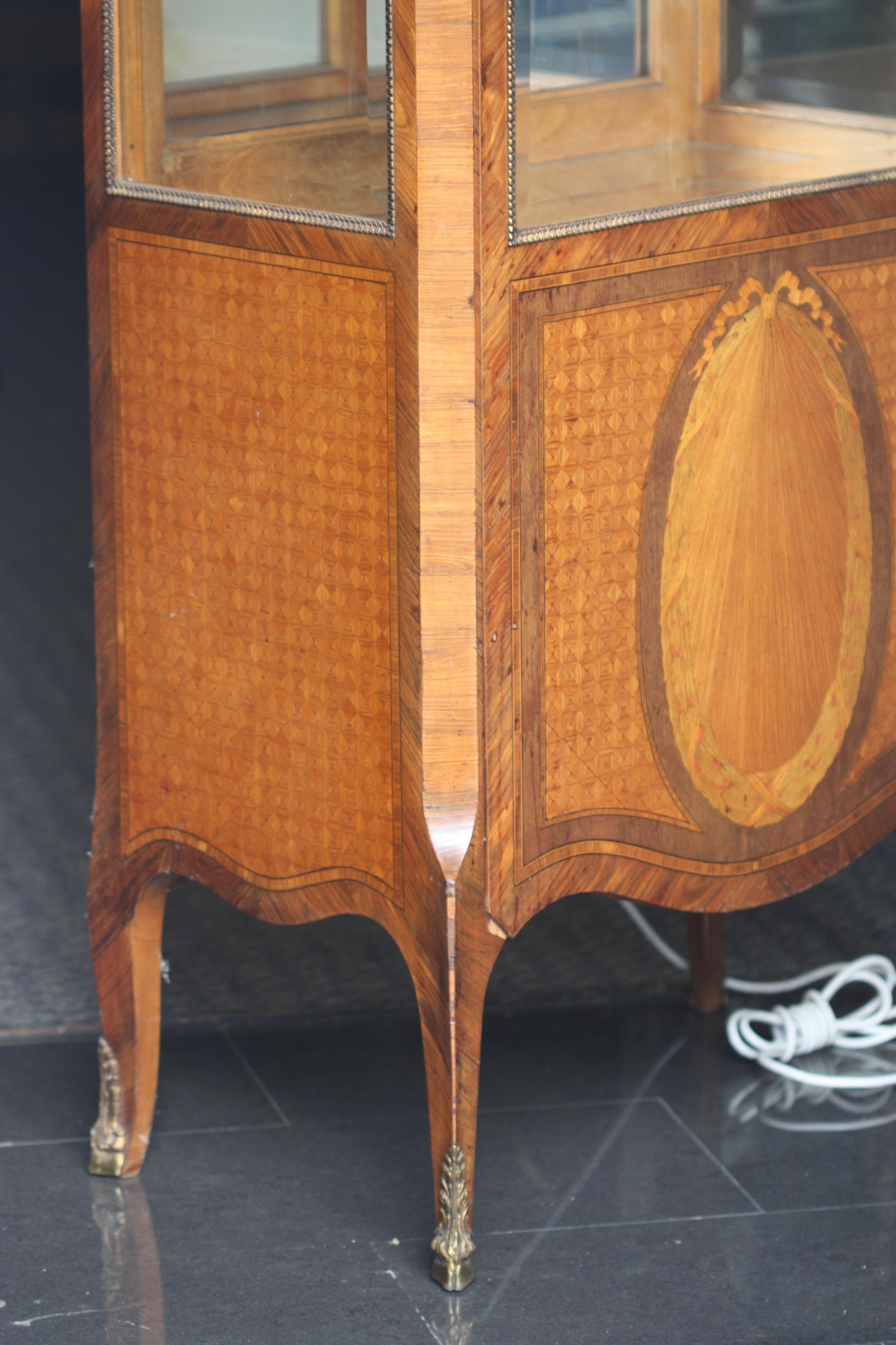 A gilt-bronze mounted burr amboyna and mahogany vitrine cabinet
French, circa 1900
All sides fitted with beveled glass and opening to shelves,
Measures: Height 63.25 in. (160.65 cm.), width 28 in. (71.12 cm.), depth 16 in. (40.64 cm.).

  