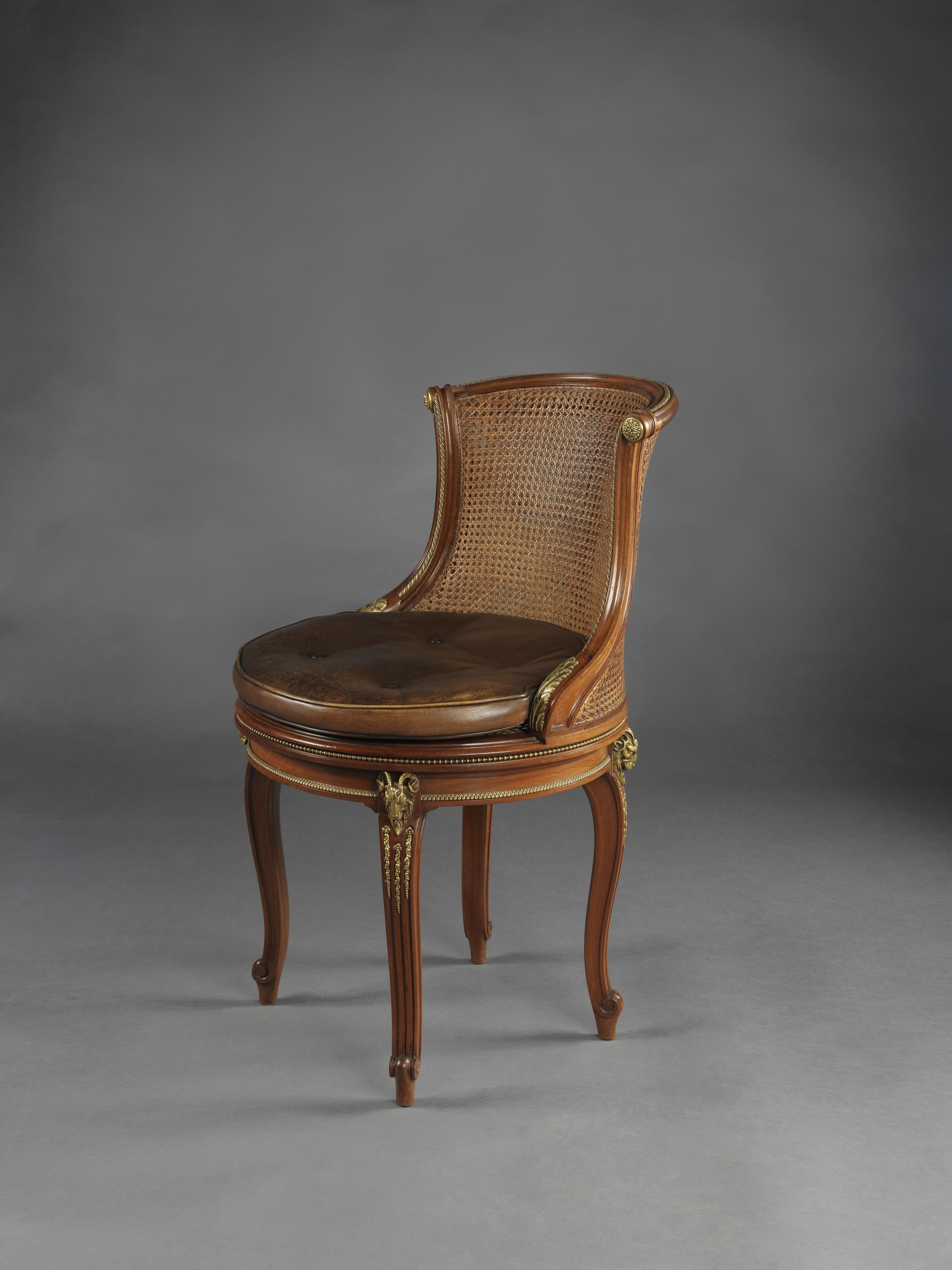 A gilt bronze-mounted mahogany desk chair by François Linke. 

French, circa 1910.

Signed 'F. Linke' to one acanthus clasp.

Linke made six versions of this chair in two sizes, in mahogany or satiné, upholstered or caned. One with gilt bronze