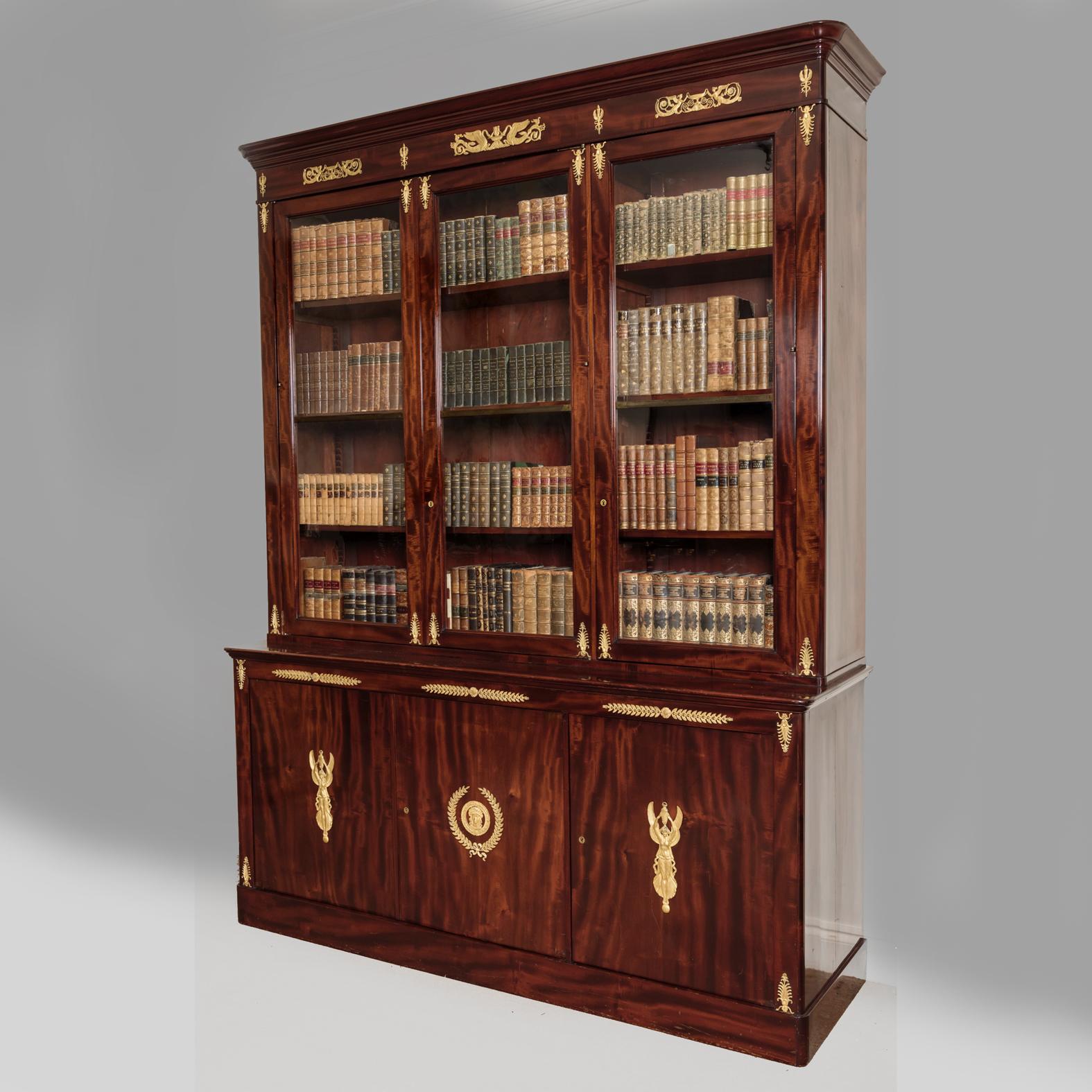 A fine gilt bronze mounted mahogany Empire library bookcase.