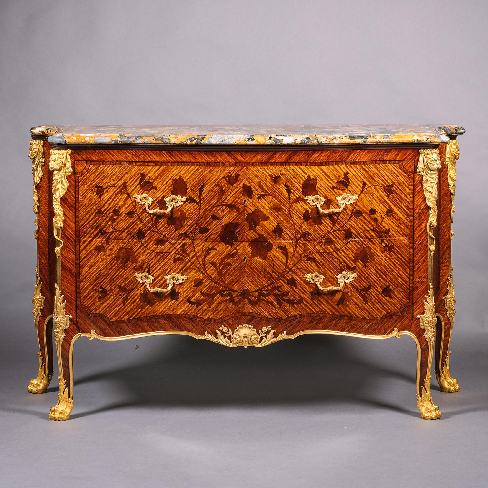 A Fine Gilt-Bronze Mounted Marquetry Commode, By Heinrich Pallenberg, Cologne. 

The original marble top is a rare yellow, black and grey brèche marble. This magnificent chest of drawers is fronted by two deep drawers decorated with superb bois de
