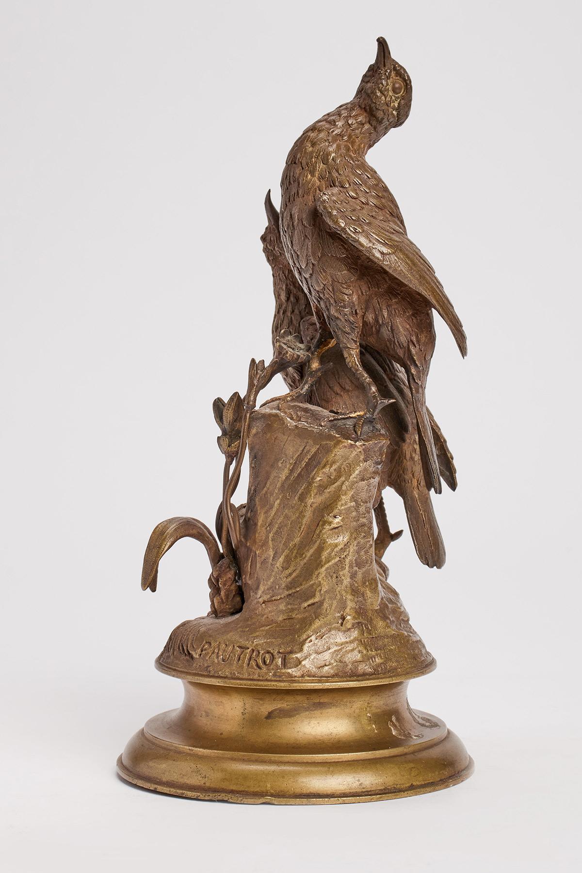 A bronze gilt sculpture of birds are standing over a tree trunk decorated with leaves and flowers. Round plane base. Signed Pautrot, France circa 1850.