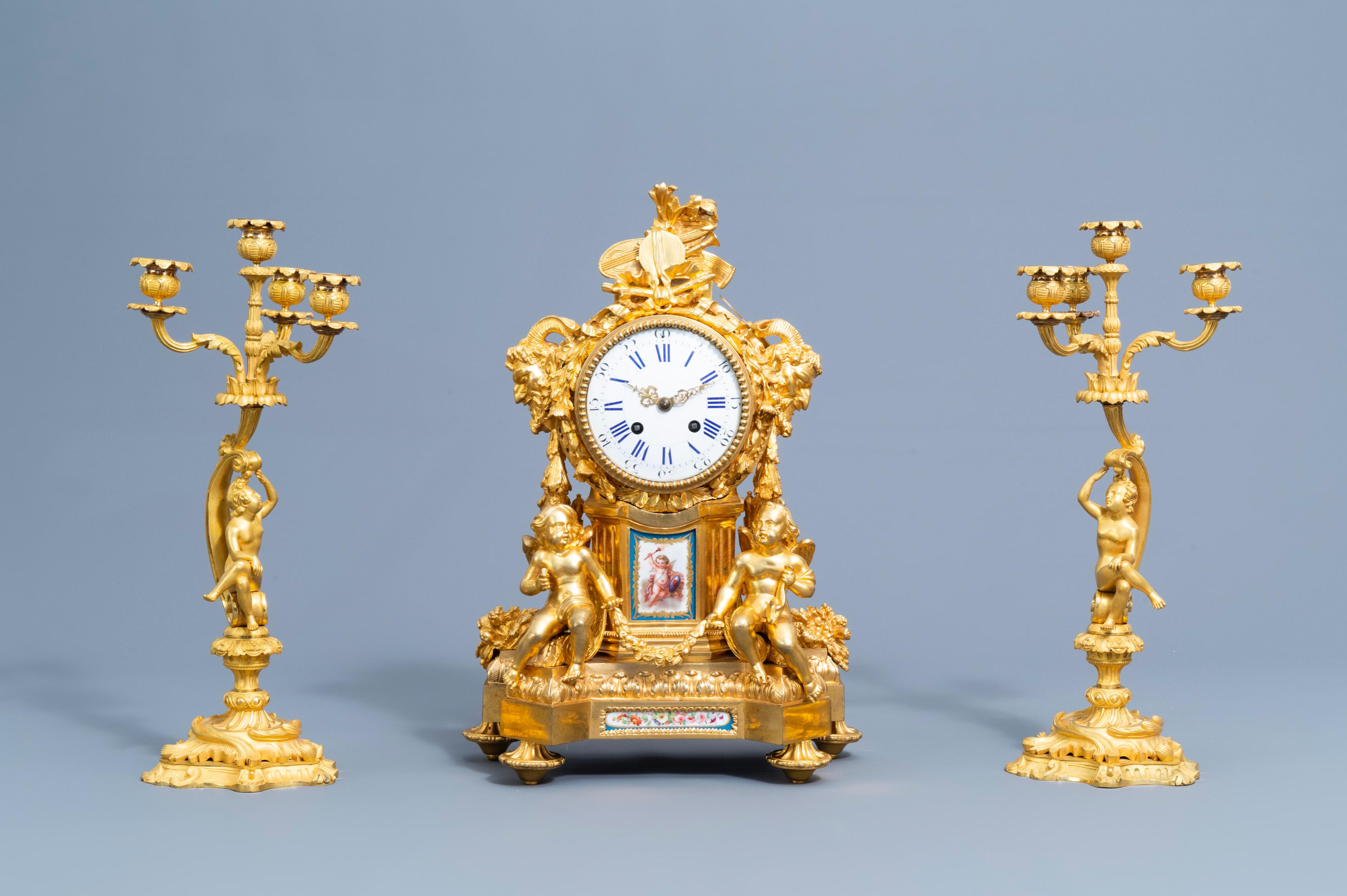 A fine French gilt bronze Sèvres style mantel clock and a pair of Louis XV style four light candelabra, 19th C. 

Clock: H: 46 cm, W: 30 cm, D: 16 cm

Candelabra: height: 43 cm, diameter: 20 cm.