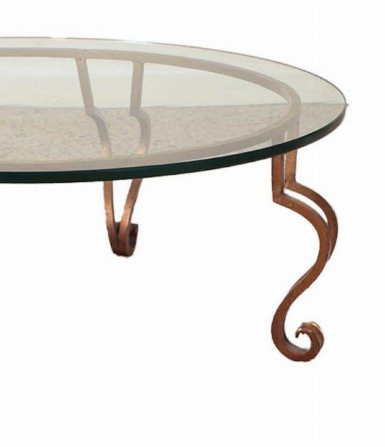 A gilt iron, glass top coffee table in the manner of Ramsay circa 1975. In Good Condition For Sale In Philadelphia, PA