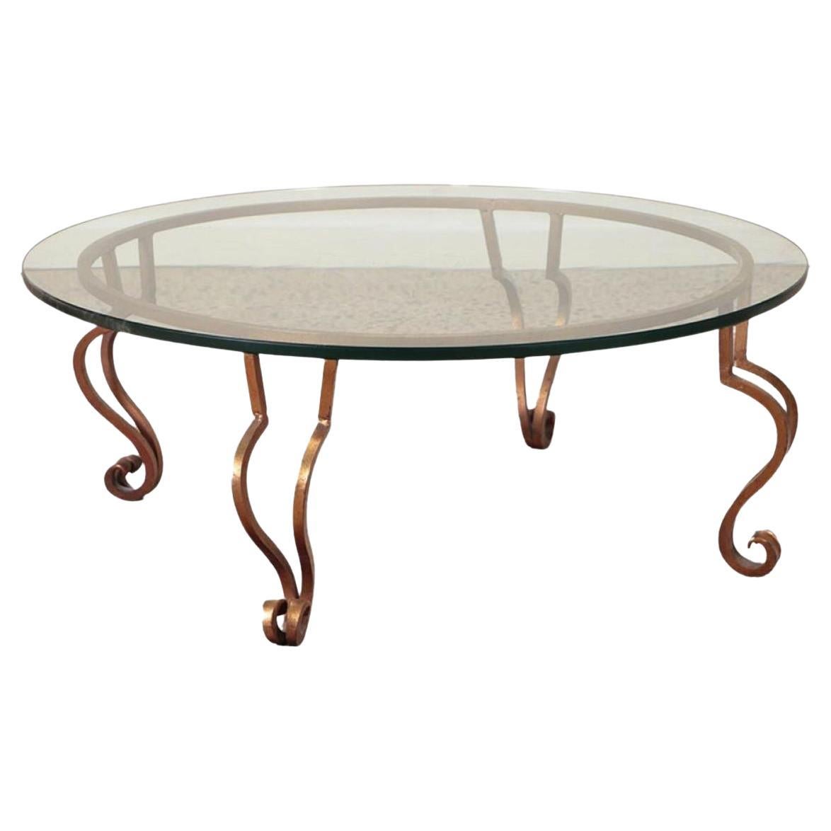 A gilt iron, glass top coffee table in the manner of Ramsay circa 1975. For Sale