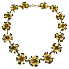 A gilt metal and emerald paste stylised floral necklace, Christian Dior, c 1957.