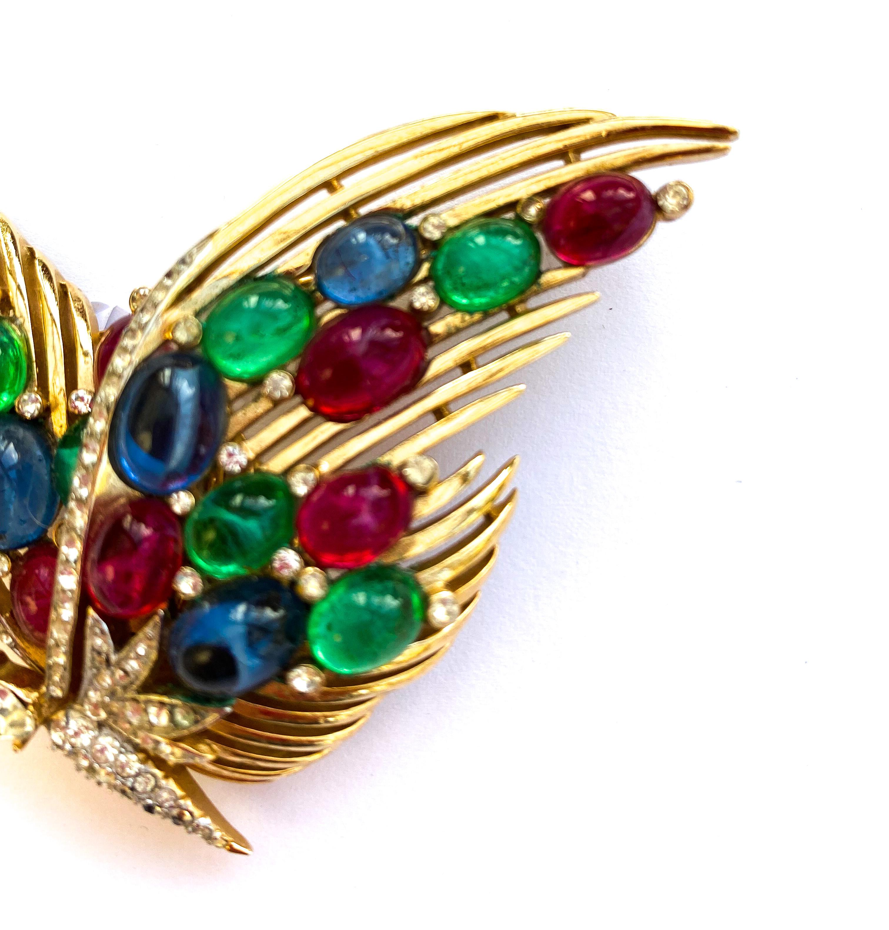 An outstanding and very rare brooch in the form of a beautiful and stylised butterfly, designed by Alfred Philippe for Trifari. It is part of a range of jewellery designed in the 'Moghul' style, using ruby, emerald and sapphire colours, reminiscent