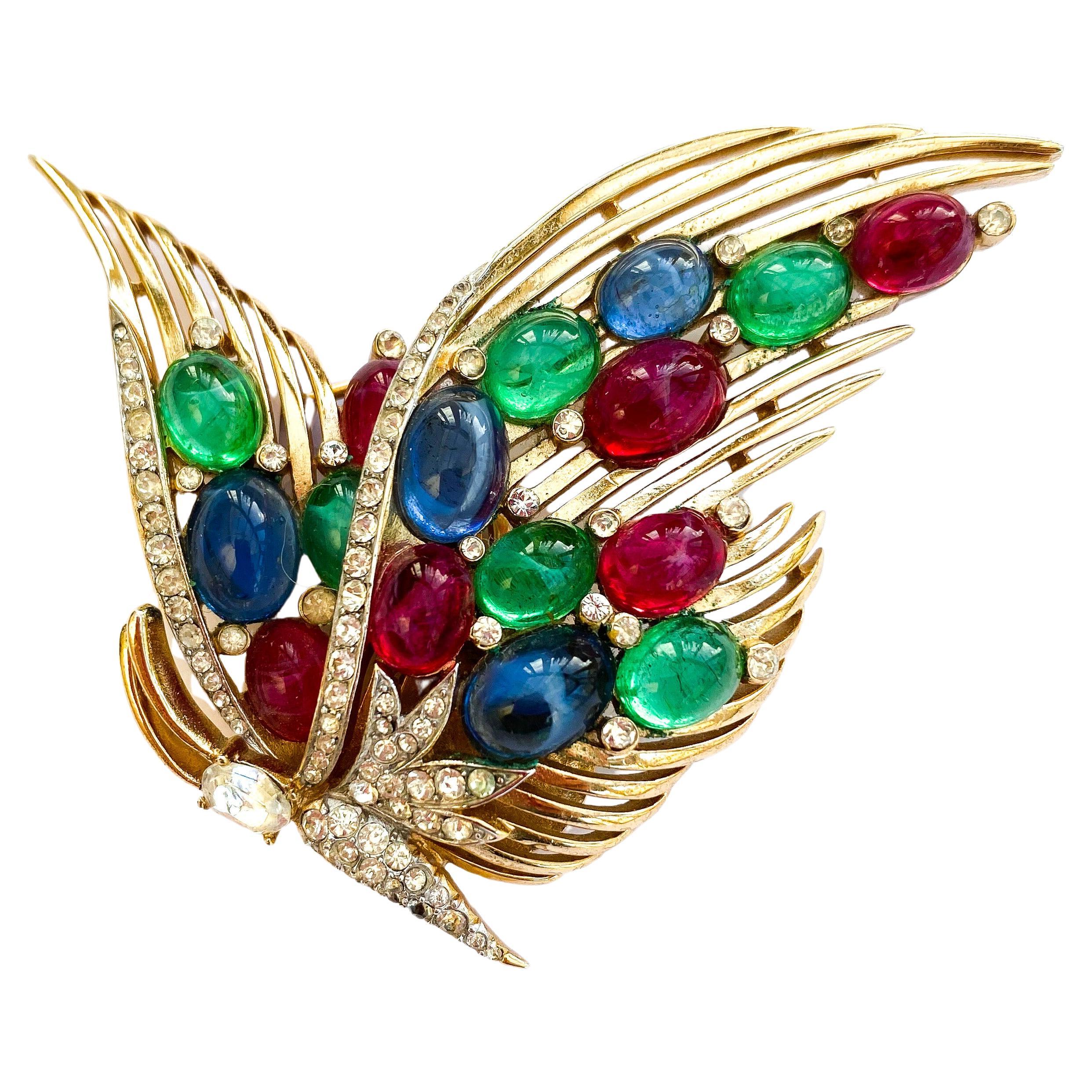 A gilt metal and glass cabuchon Moghul style 'butterfly' brooch, Trifari, 1950s. For Sale
