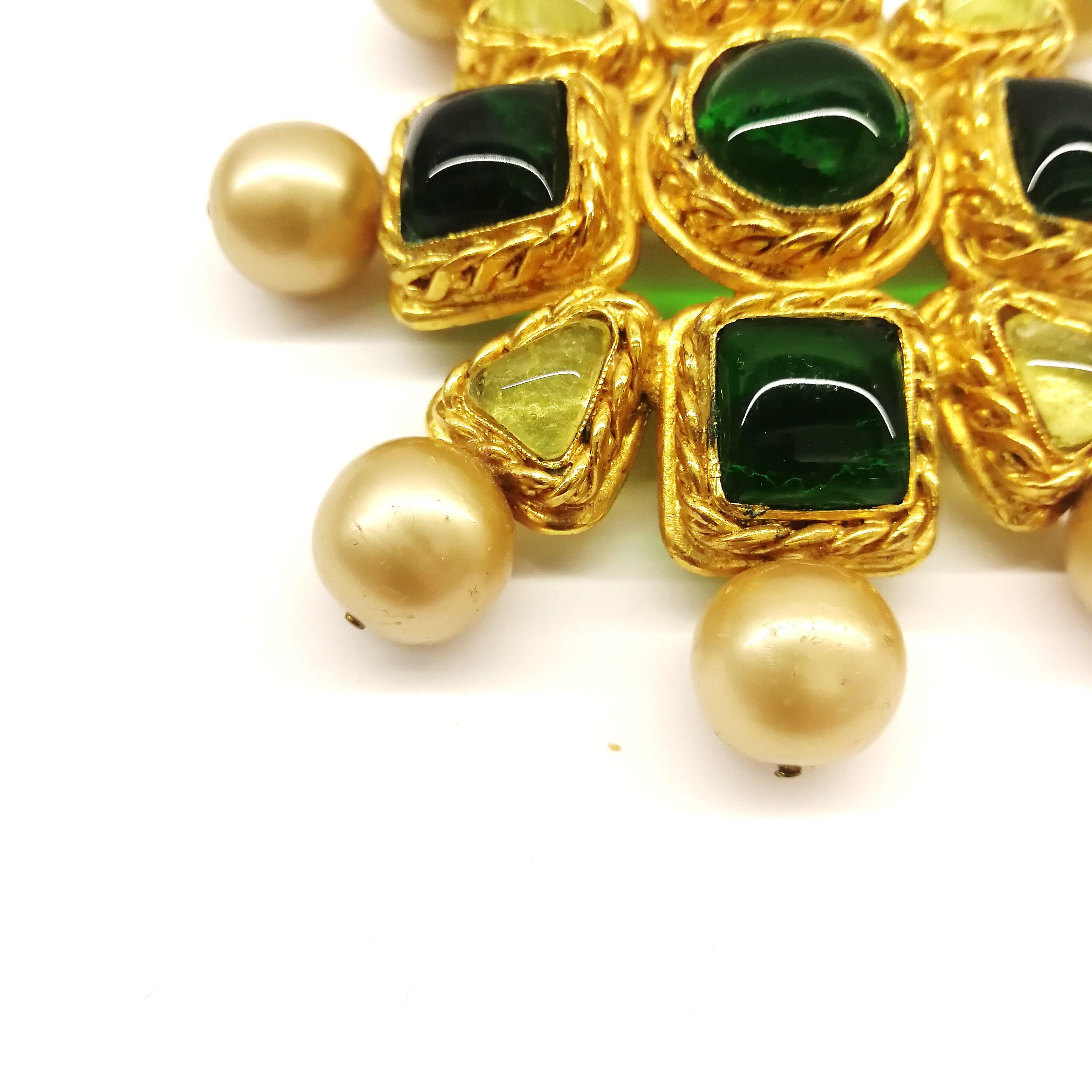 This iconic design, from  1986, was designed by Victoire de Castellane for Chanel, a period during which she designed most of the Chanel jewels that are so collectable and inspire today. Made of gilt metal, with peridot and emerald poured glass, and