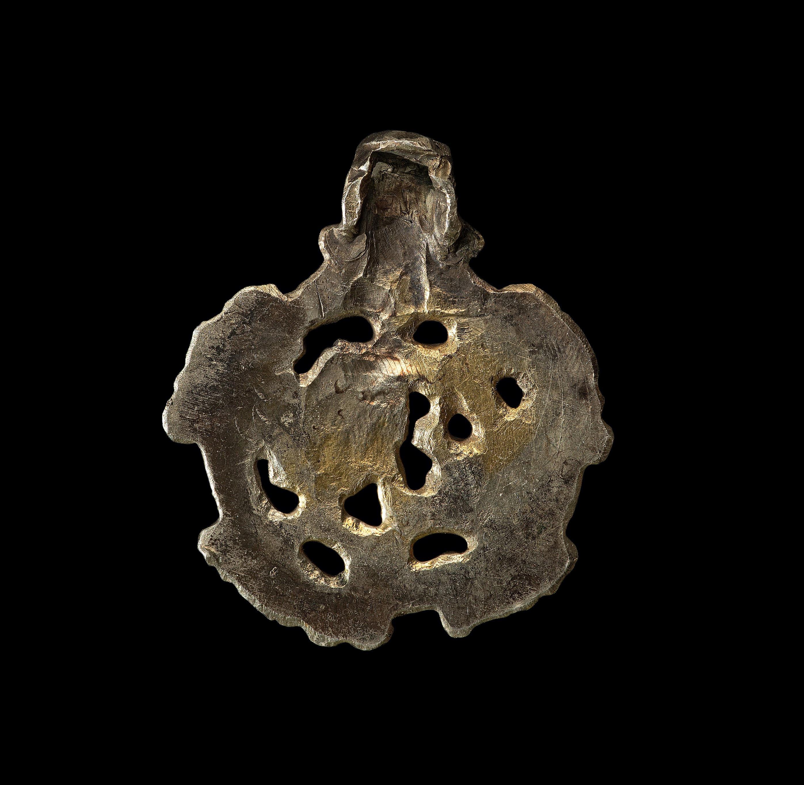 Origin: Viking inhabited area of Europe.

Gilt silver. A Borre-type concave-section pendant with integral suspension loop. The openwork plaque with three-band border and four beast-head panels, internal stylized zoomorphic beast.

Measures: