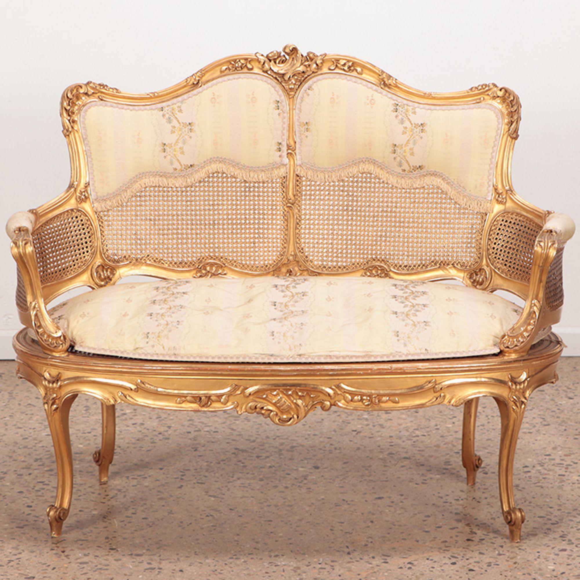 A giltwood and carved French Louis XV style settee in original gilt finish, circa 1900.