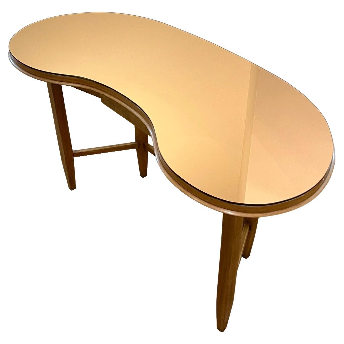 A Gio Ponti Console table in walnut and copper colored glass