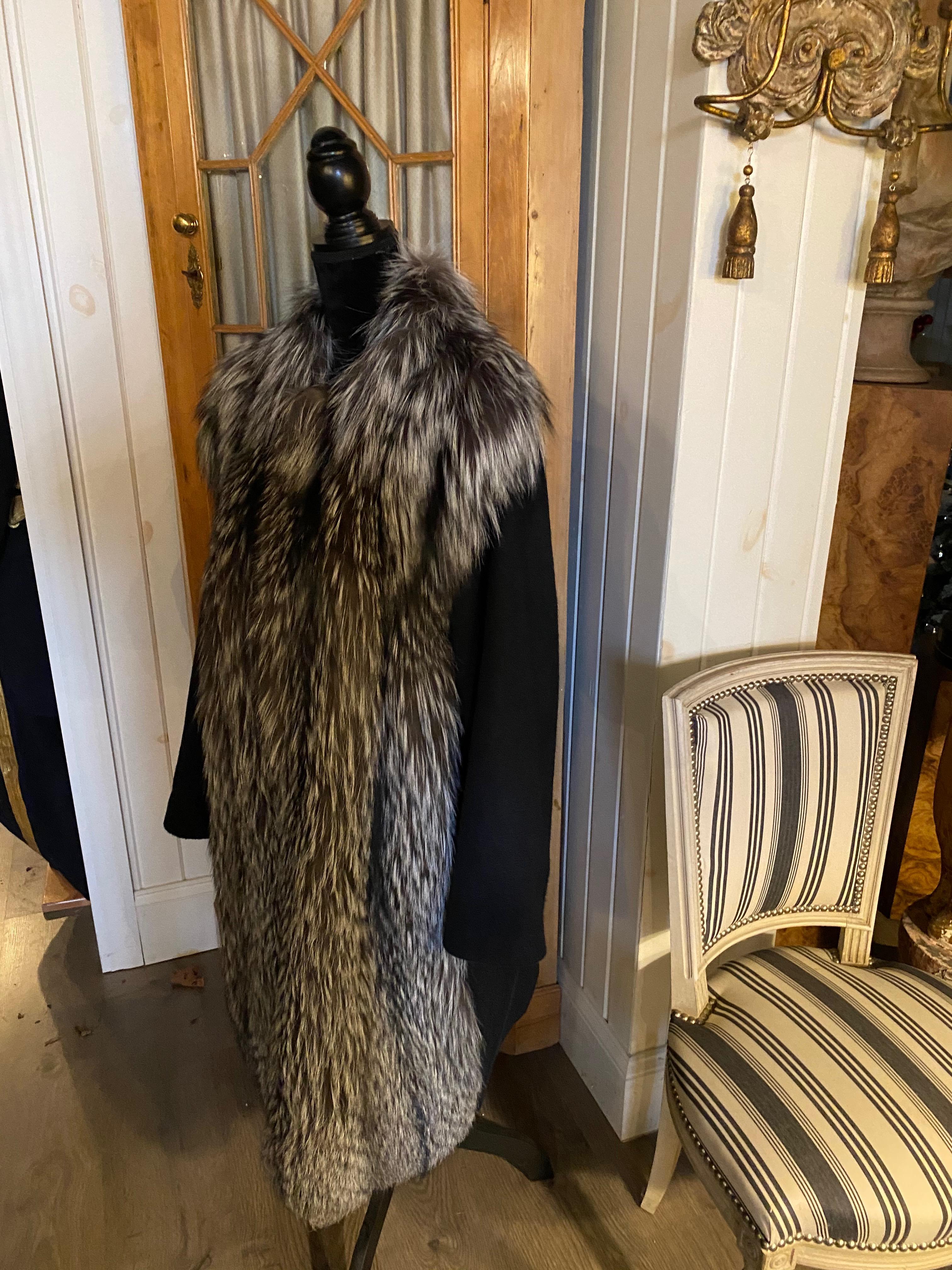 A Giuliana Teso Cashmere And Fox Coat, 3/4 Length.  Very High Grade Cashmere. 4-5 ply.
3/4 length collarless black cashmere coat with silver fox front
Size 14