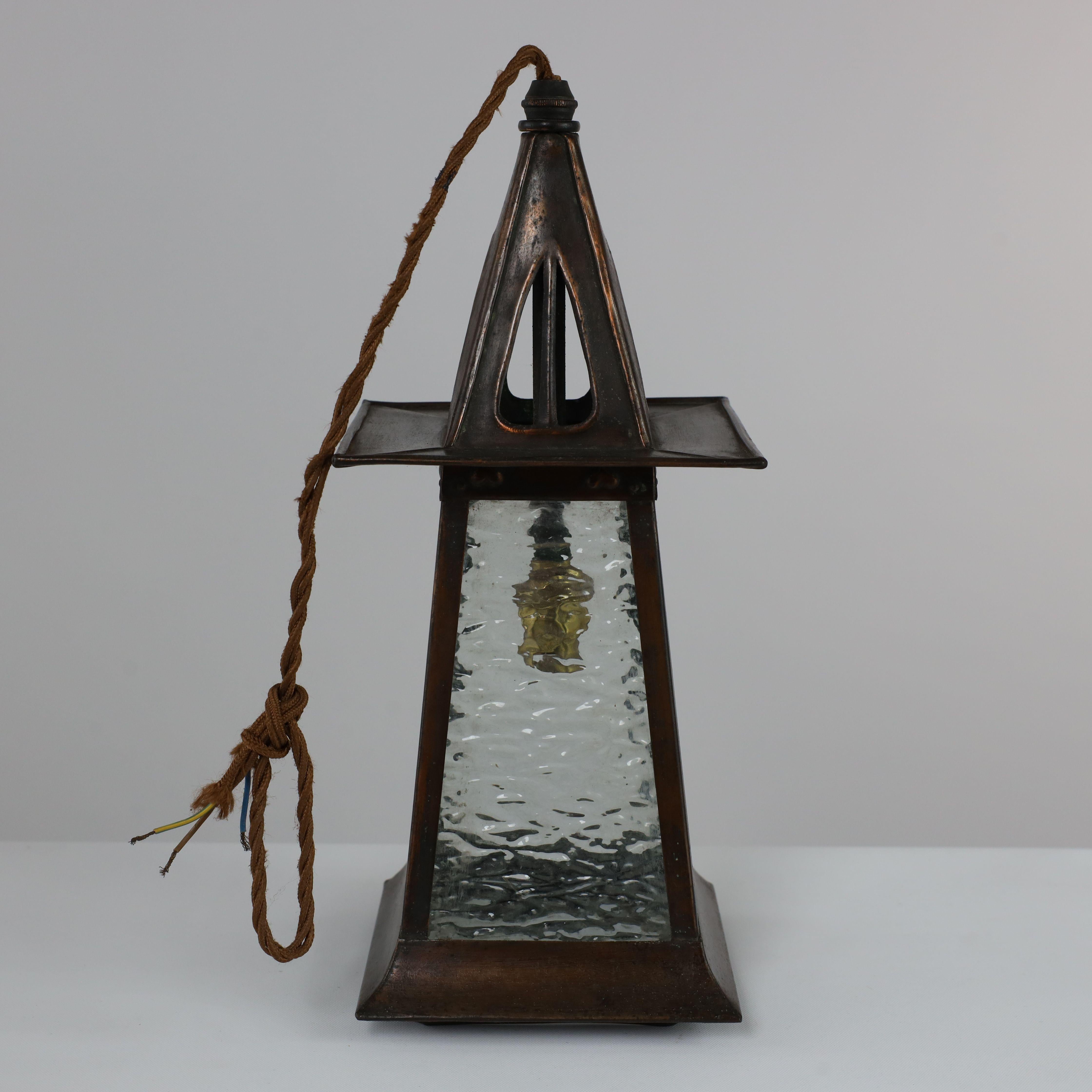 A Glasgow school anodised copper ceiling light with pierced upside down split heart to the top and little repousse split hearts just above the glass.