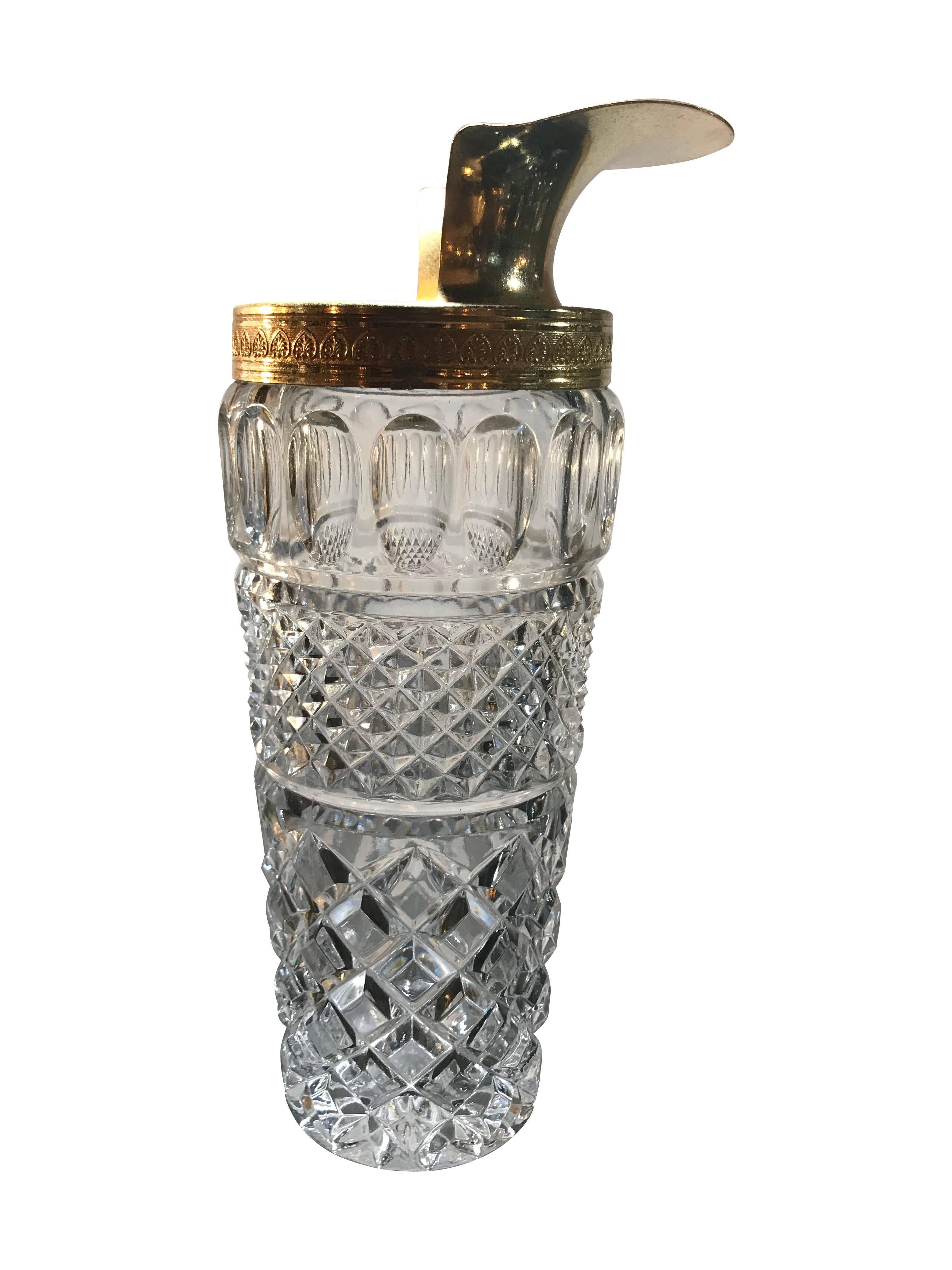 A faceted glass and gilt metal cocktail mixing jug or pourer with gilt metal mixing spoon.