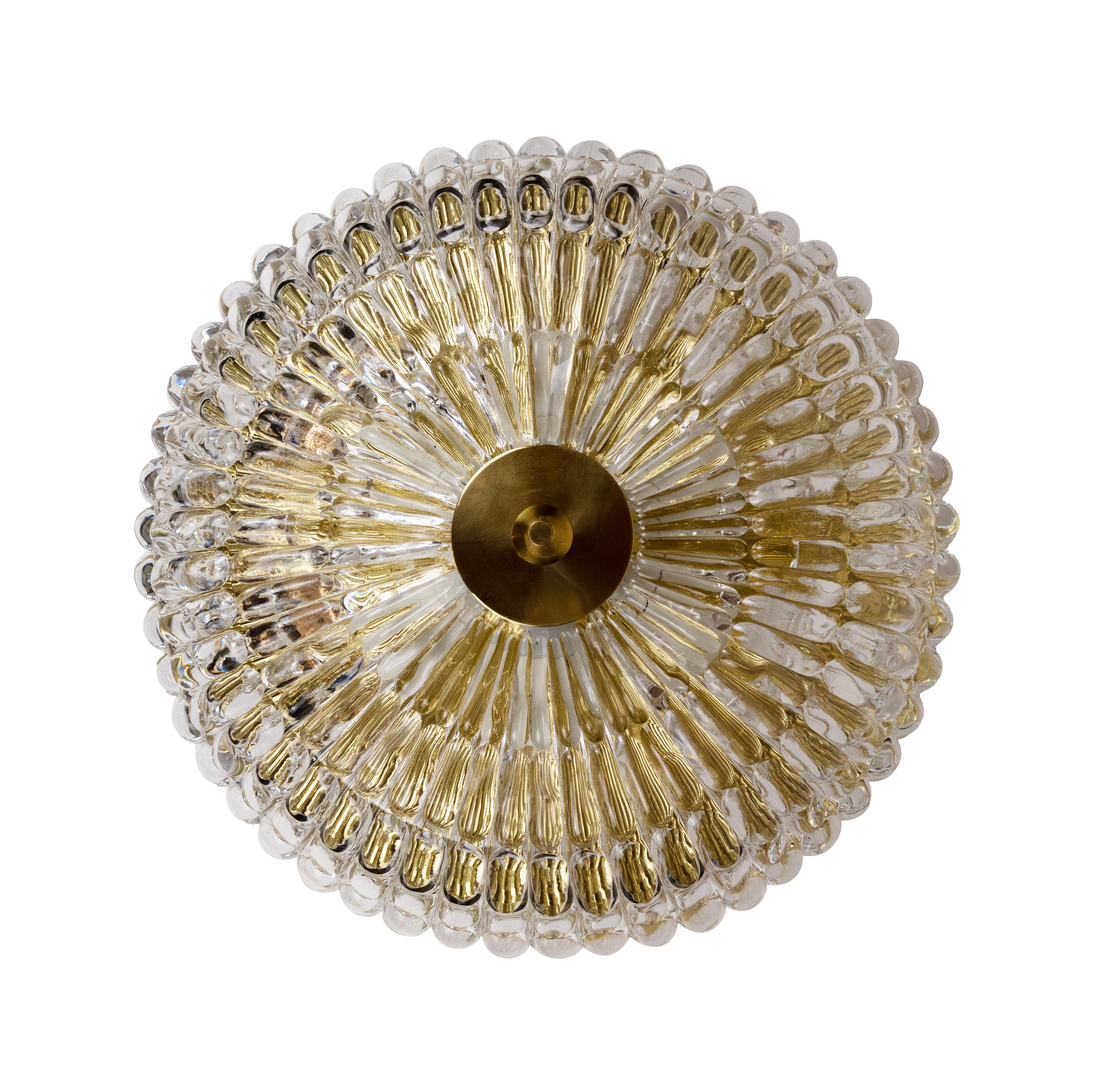 A cast glass flush mount by designer Carl Fagerlund for Swedish maker Orrefors. The rounded dome glass with scalloped edge secured with the original polished brass finial. Circa 1950, still with original makers mark. Price includes new UL wiring for