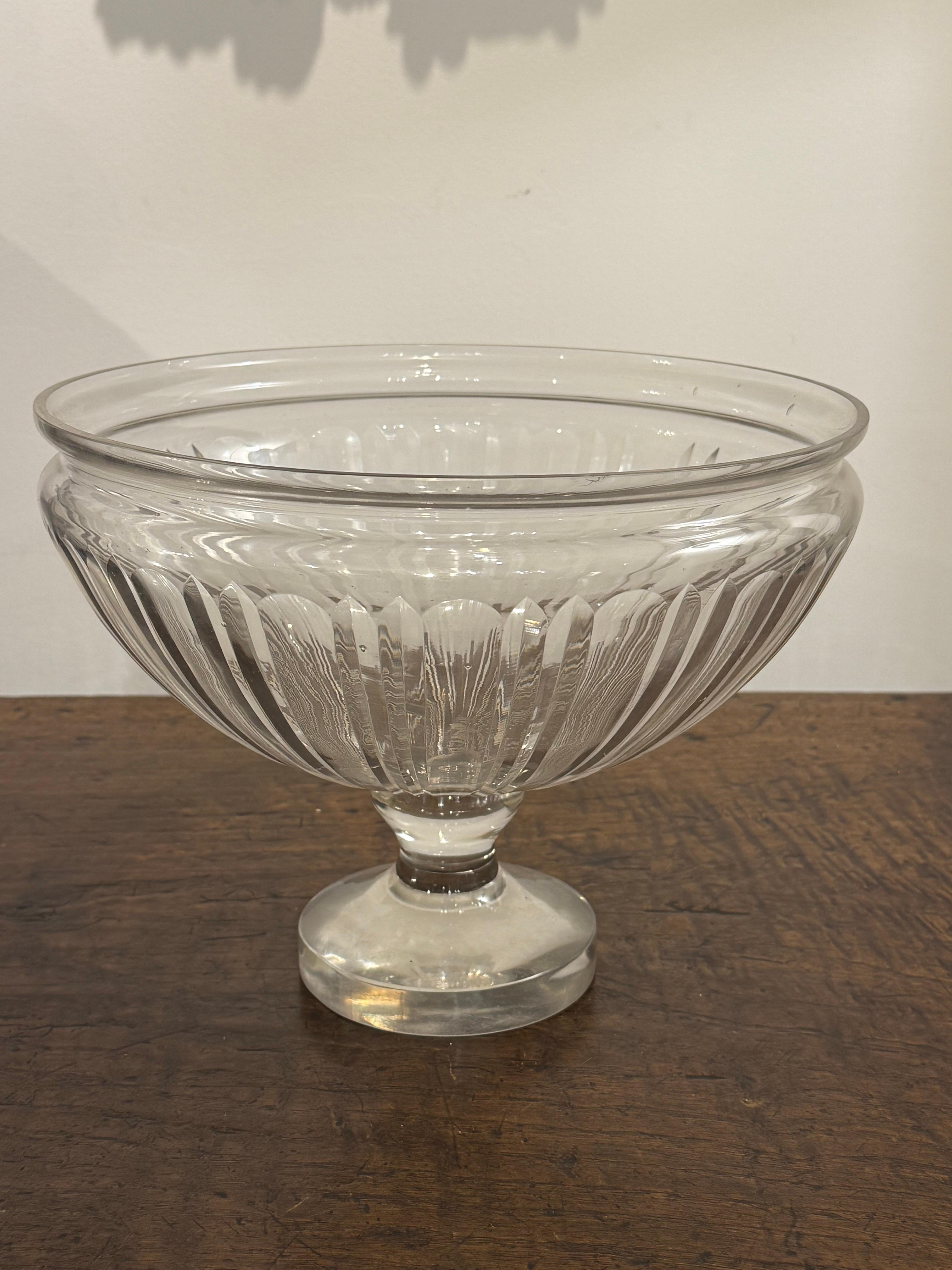 A Glass Punch Bowl
With a reeded body raised on a facetted foot.

Provenance: Private Australian Collection.

Dimensions:
Height: 23cm.
Diameter: 30cm.