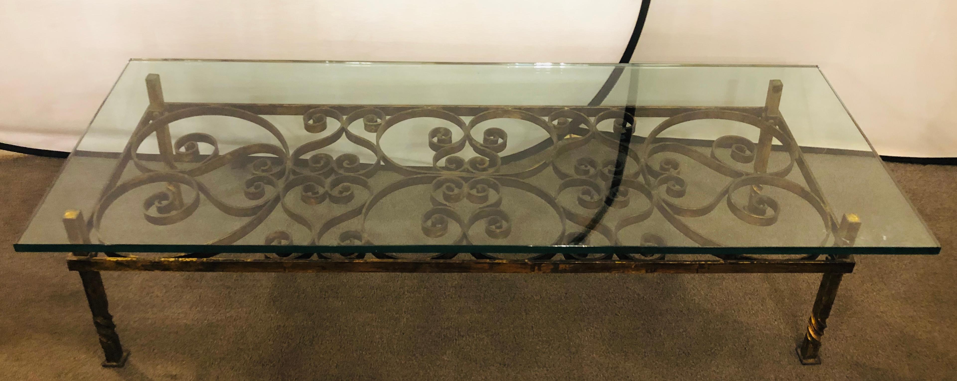 A glass top wrought iron industrial coffee or low table
A rectangular shaped coffee or cocktail table featuring a scroll and heart form design and a thick glass top. A stylish addition to your living room or office.

 