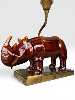 A glazed cerameric Rhino design table lamp with brass feet - 20th century