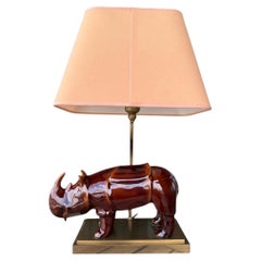 A glazed cerameric Rhino design table lamp with brass feet - 20th century