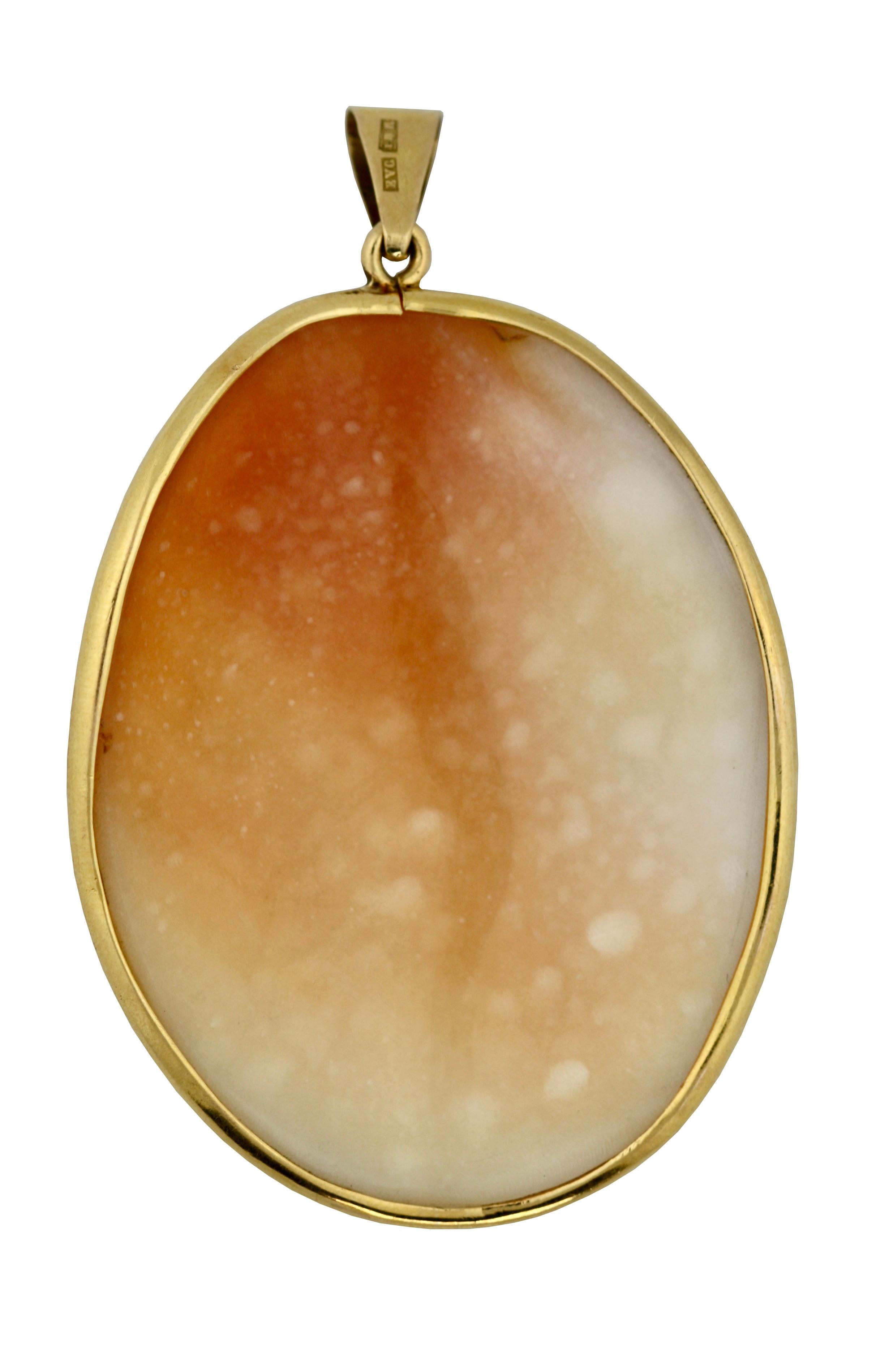 A Gold and Cameo Pendant, depicting a Victorian lady in profile looking right in a gold frame, pendant hook 
Height 2 in. (5.08 cm.) 