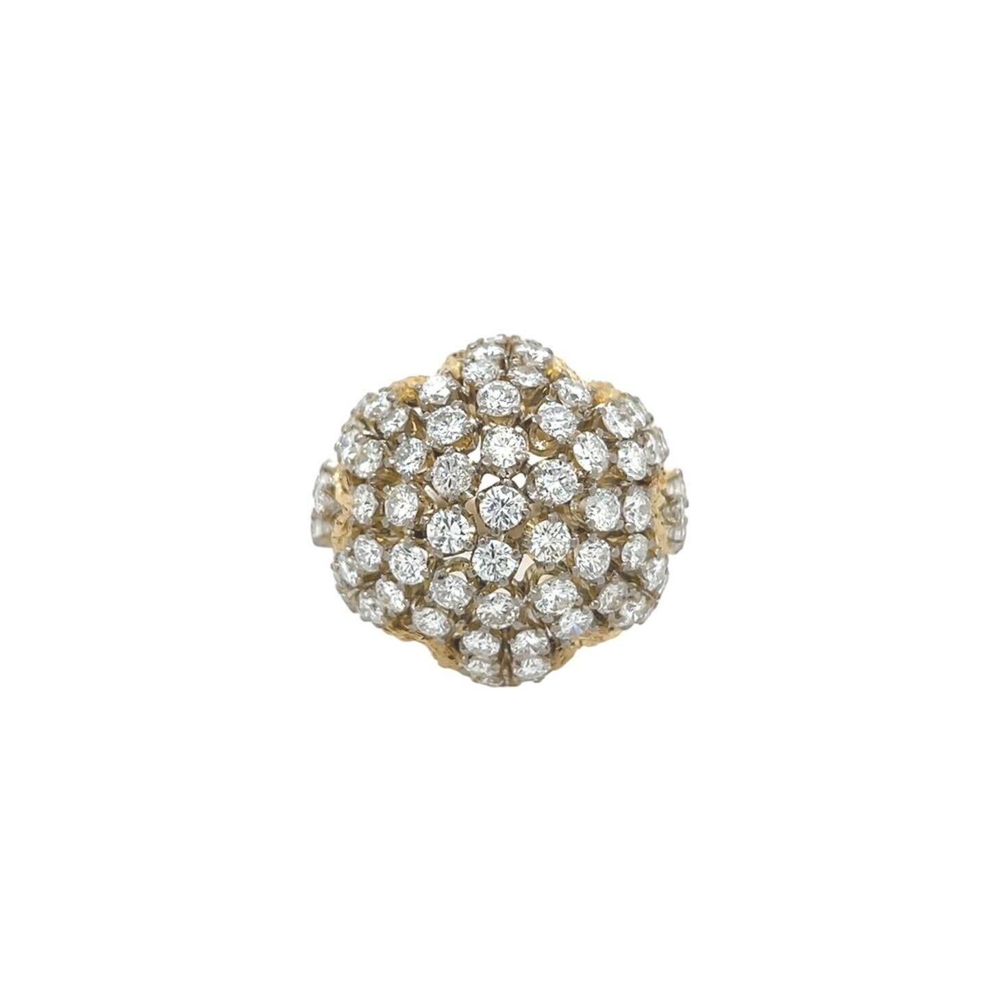 An 18 karat yellow gold and diamond ring, circa 1960s.  The bombe ring designed as dome of approximately seventy two (72) round brilliant cut diamonds above a textured zigzag border with a similarly textured band.  Total diamond weight approximately