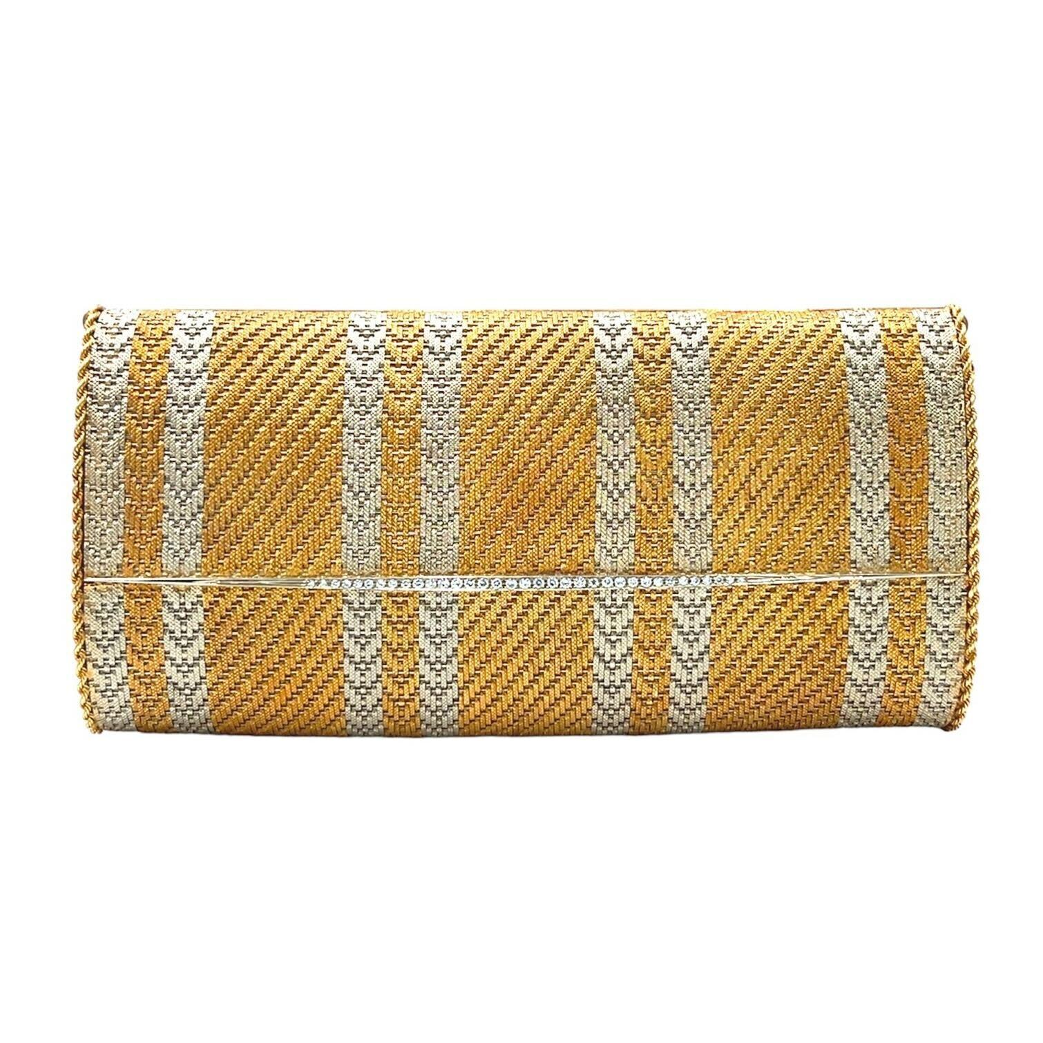 An 18 karat yellow and white gold and diamond evening bag.  Italian.  The oblong yellow gold mesh bag enhance with four pairs of vertical white gold herringbone stripes and highlighted with a graduated horizontal row of approximately thirty five