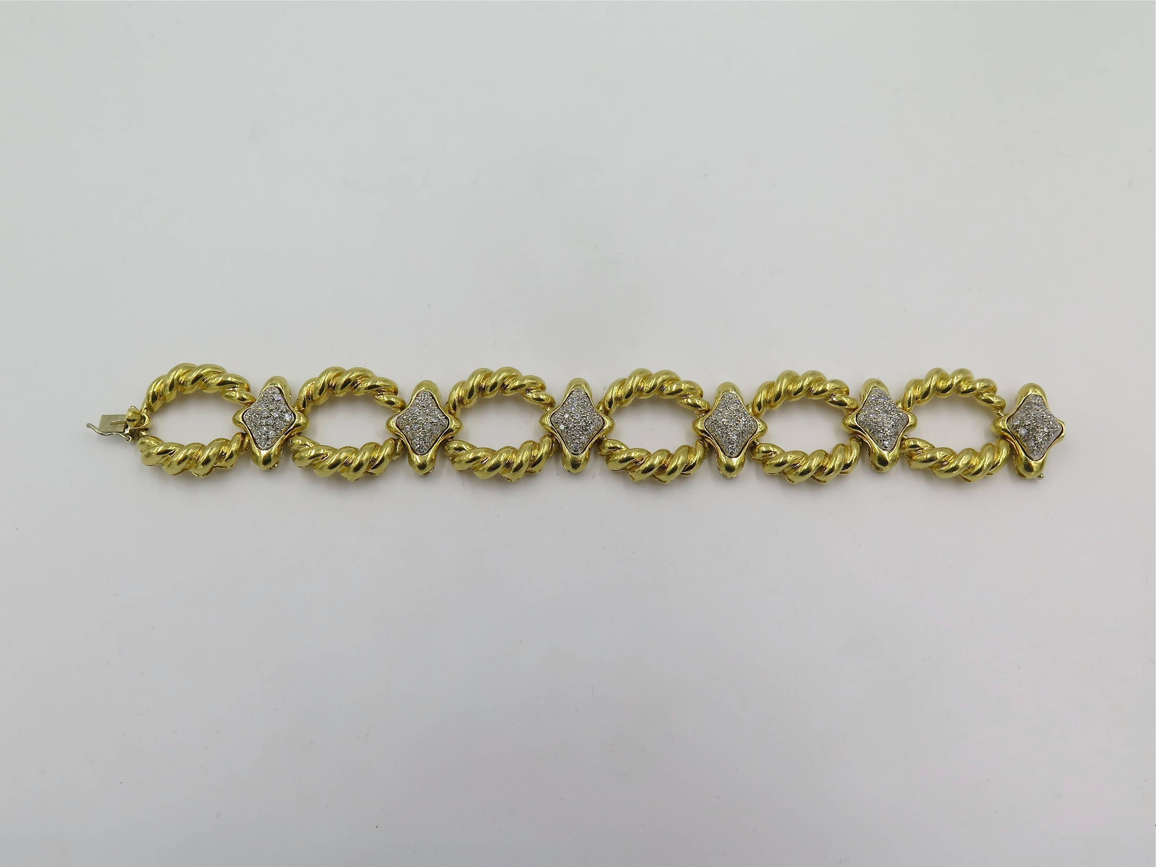 An 18 karat yellow gold and diamond bracelet.  Circa 1980’S. Designed as a line of fluted oval links, spaced by navette shaped pave set diamond links. One hundred and twenty six diamonds weigh approximately 1.40 carats. Length is approximately 7