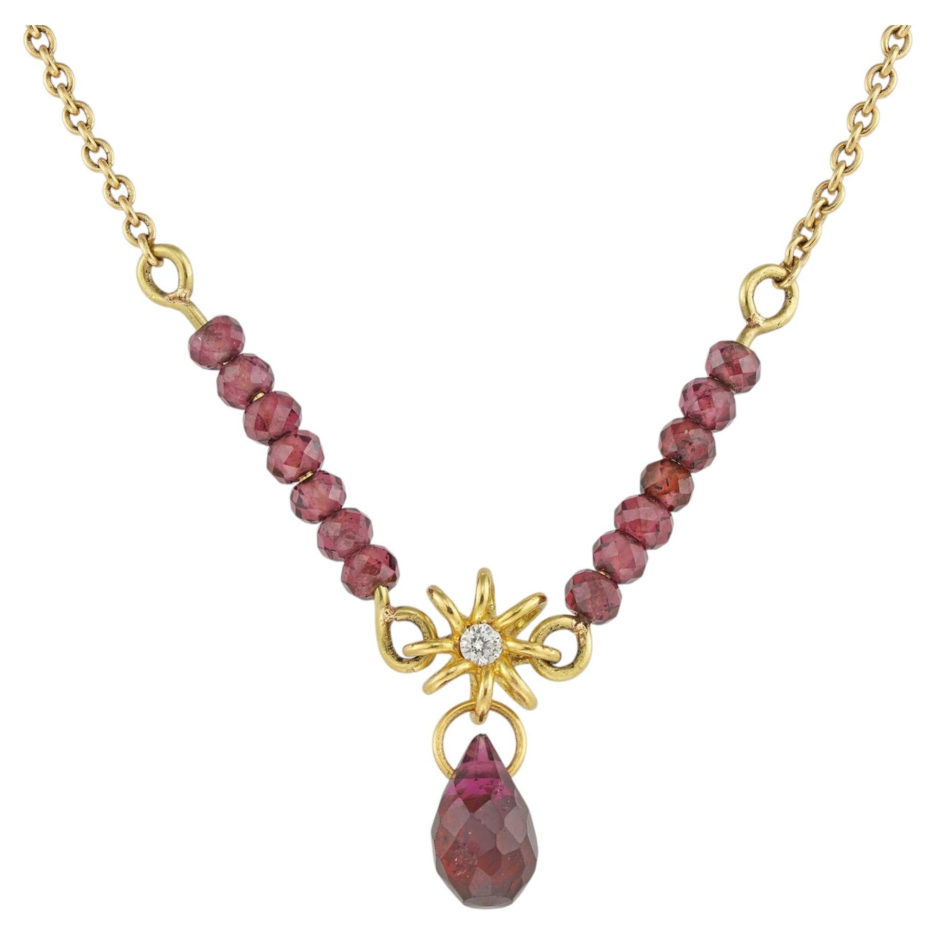 A gold and garnet necklace by Lucie Heskett-Brem For Sale