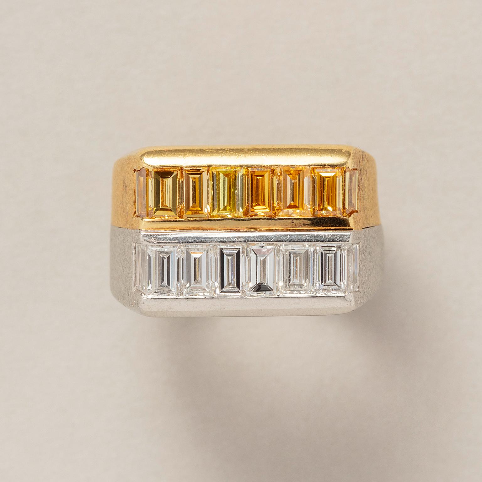 An 18 carat yellow gold and platinum row ring, the yellow gold part is set with a line of 8 fancy yellow baguette cut diamonds (app. 1 carat Vvs) and the platinum row is set with 8 white baguette cut diamonds (app. 1 carat F-G, Vvs), the shank is