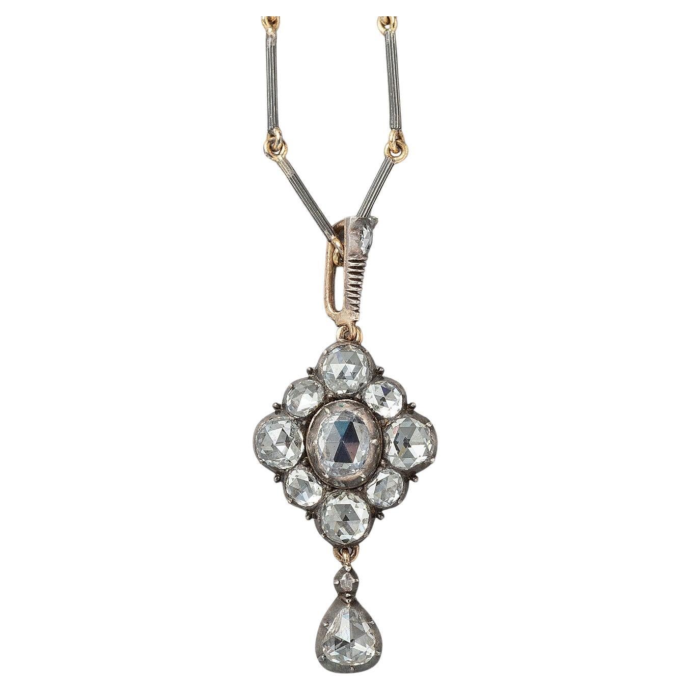 A gold and silver and rose cut diamond pendant