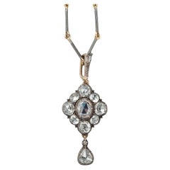 A gold and silver and rose cut diamond pendant